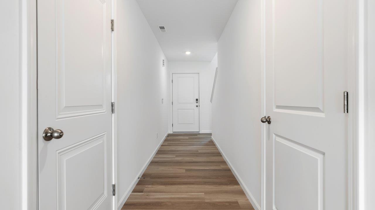 front door and foyer with lvp flooring and white walls