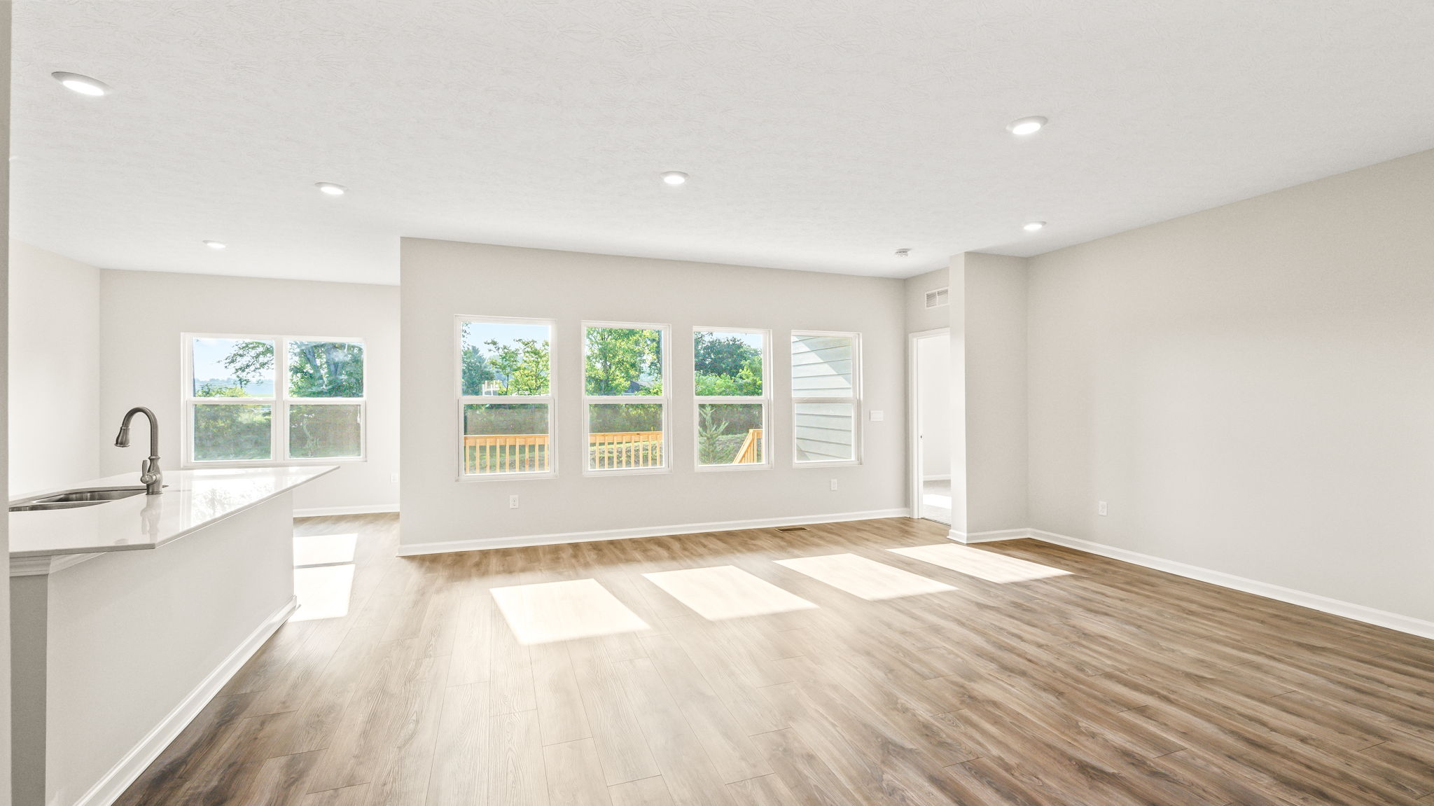 Living room area with windows to backyard