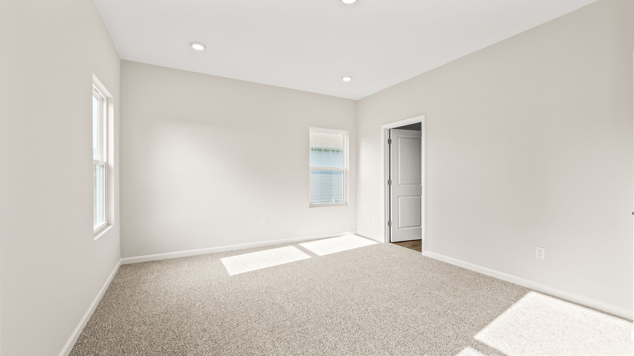 Carpeted primary bedroom