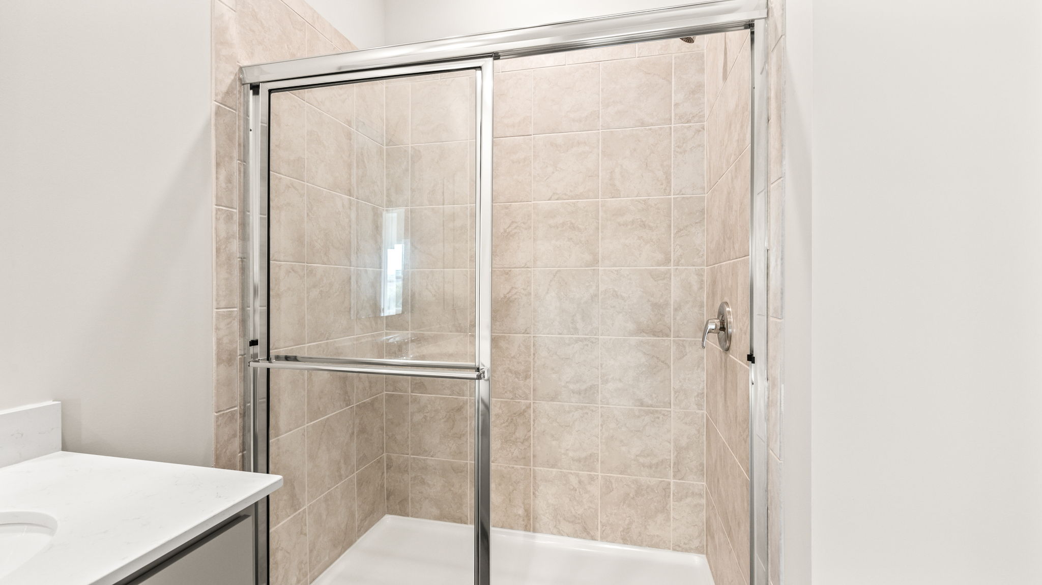 Closeup of shower with sliding glass door