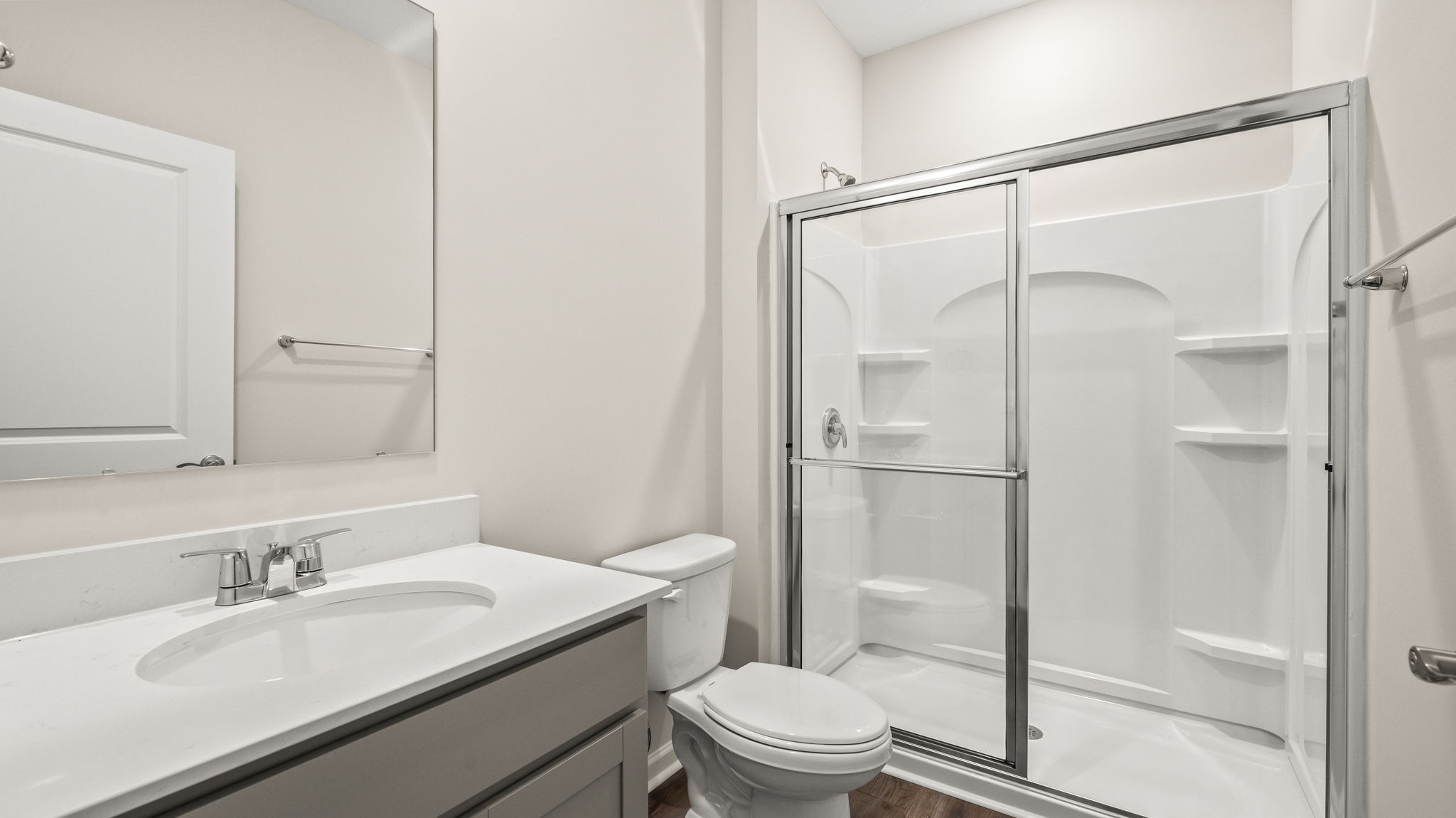 Sliding glass door shower next to toilet