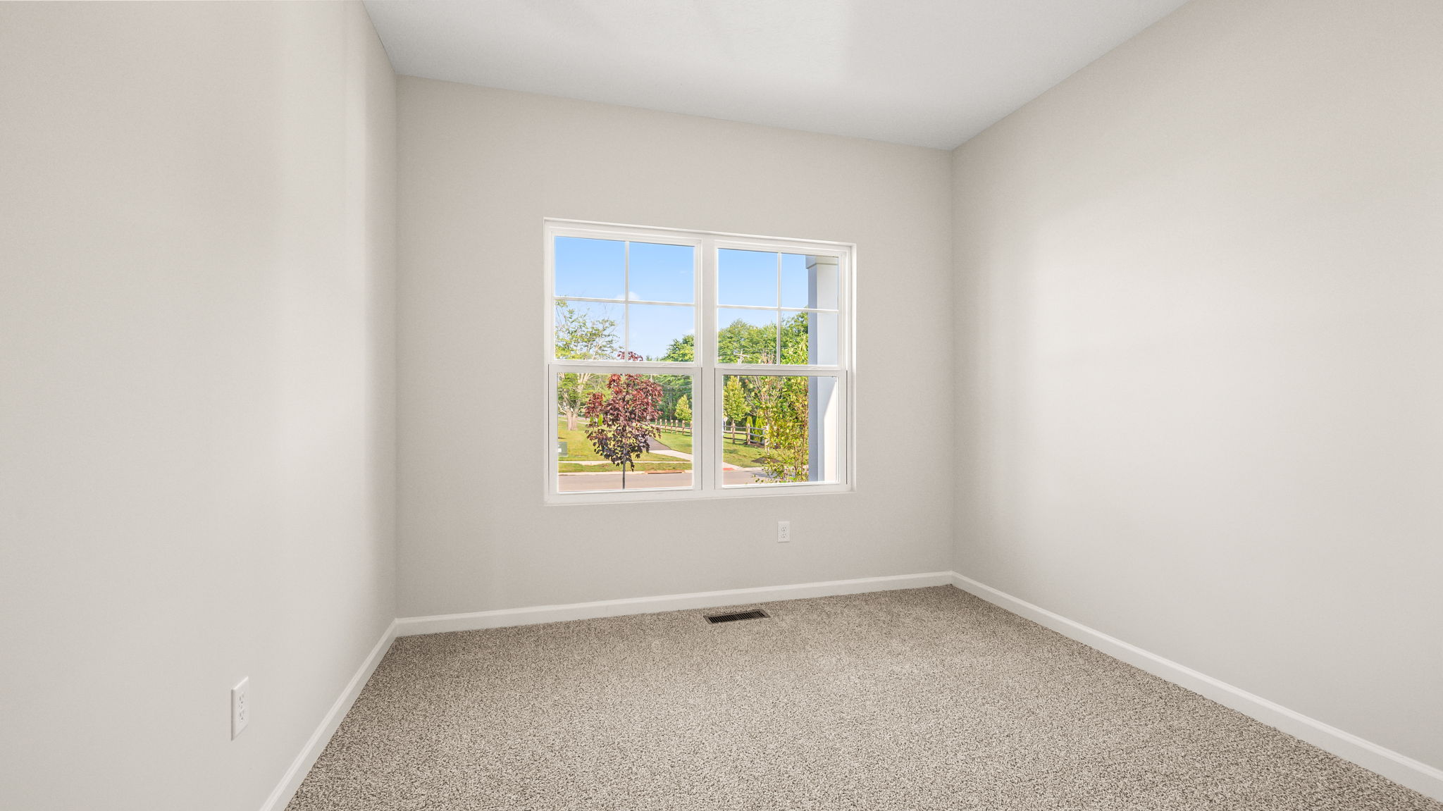 Carpeted bedroom with window