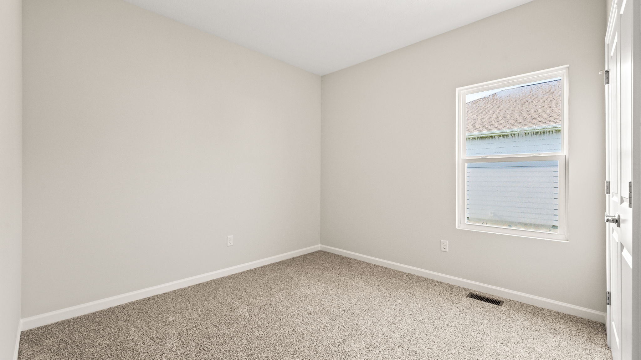 Carpeted bedroom with window