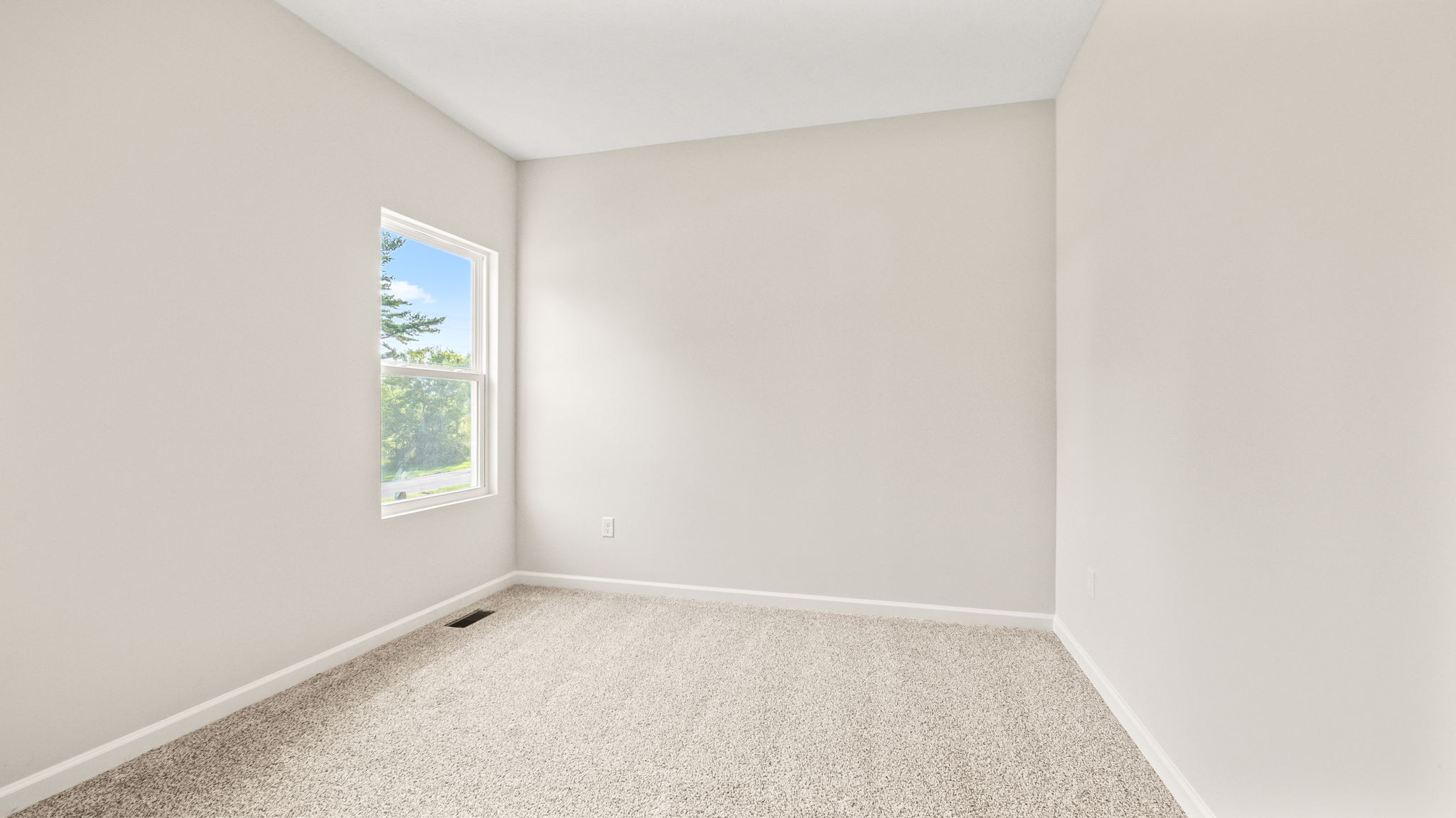 Carpeted bedroom with window
