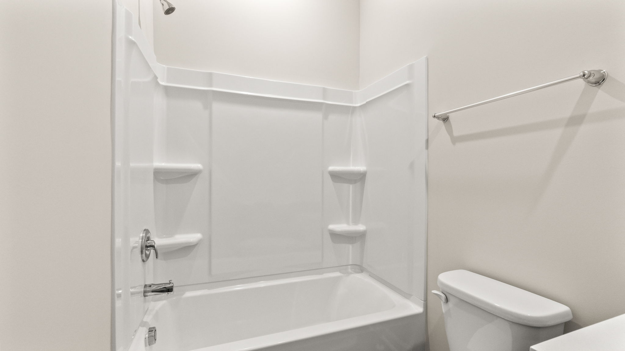 Closeup of bathroom tub with tiered shelving