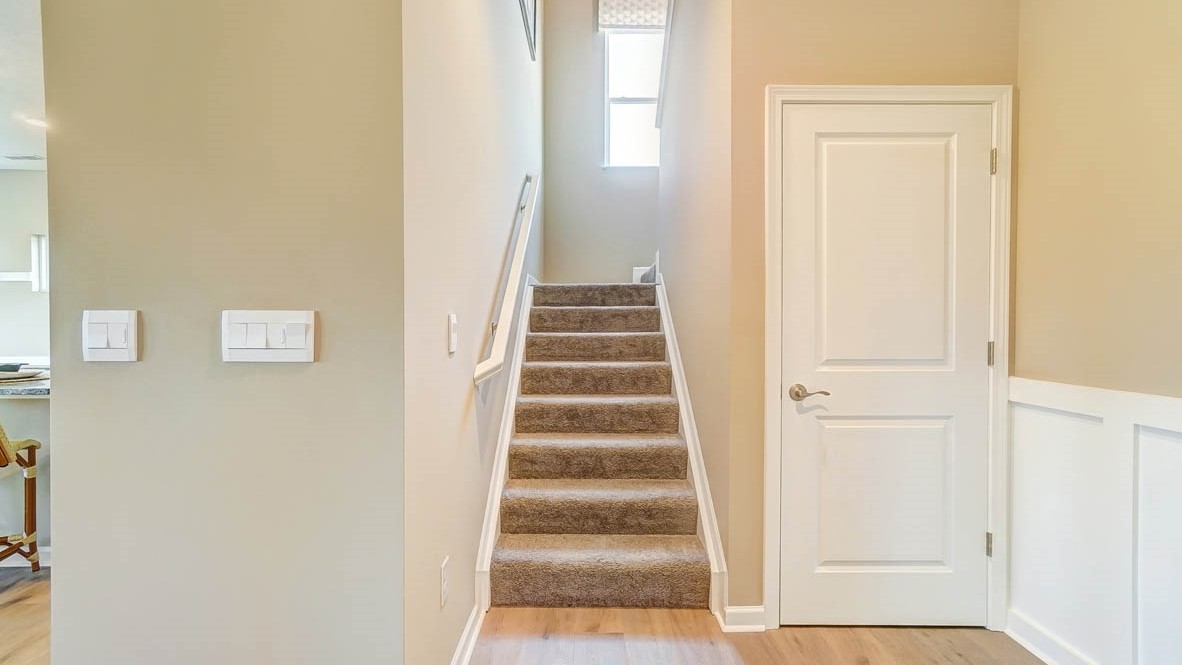 stairs heading upstairs with storage closet.