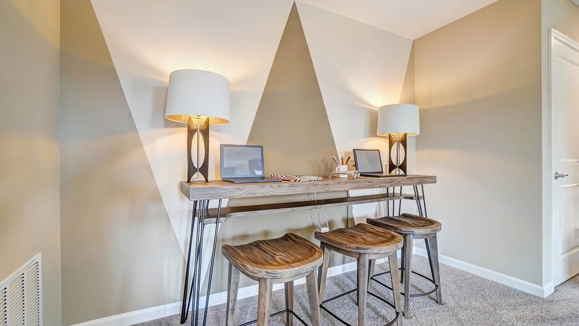 work bench in loft with lighting and laptops.