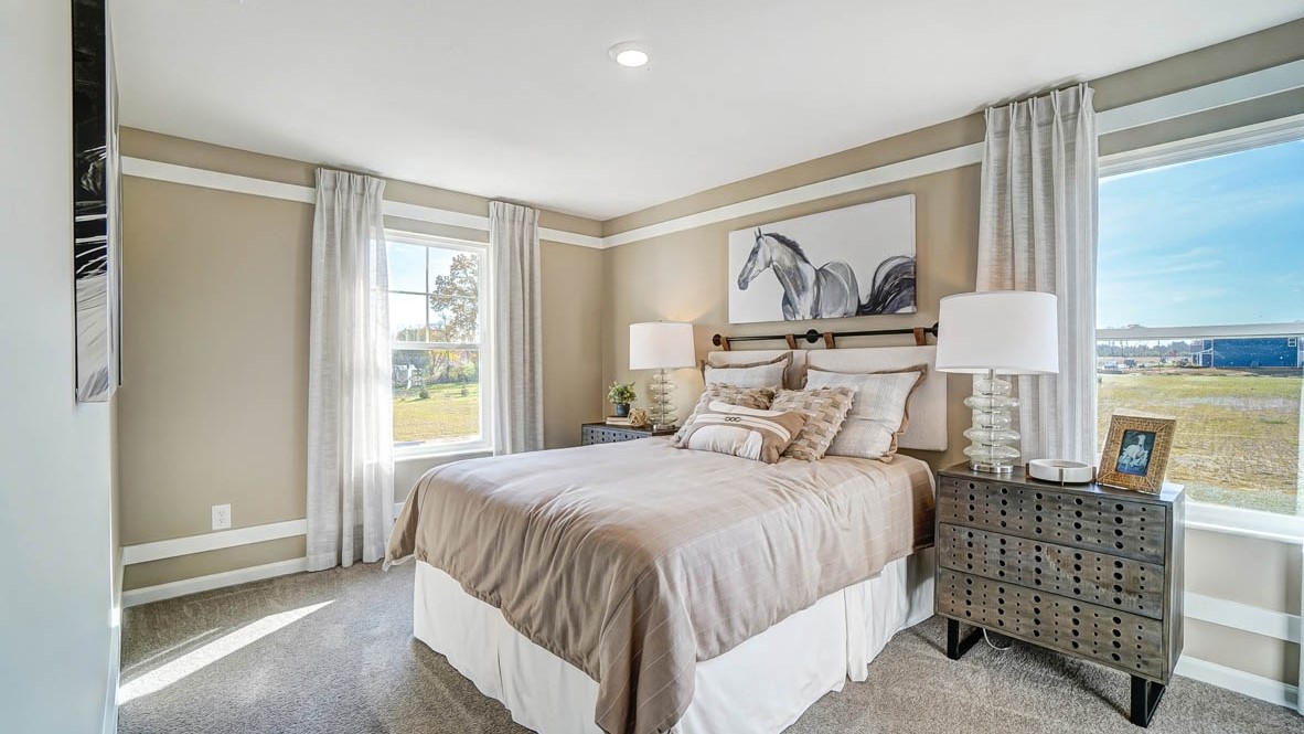 bedroom with large bed modern art and bedside tables.