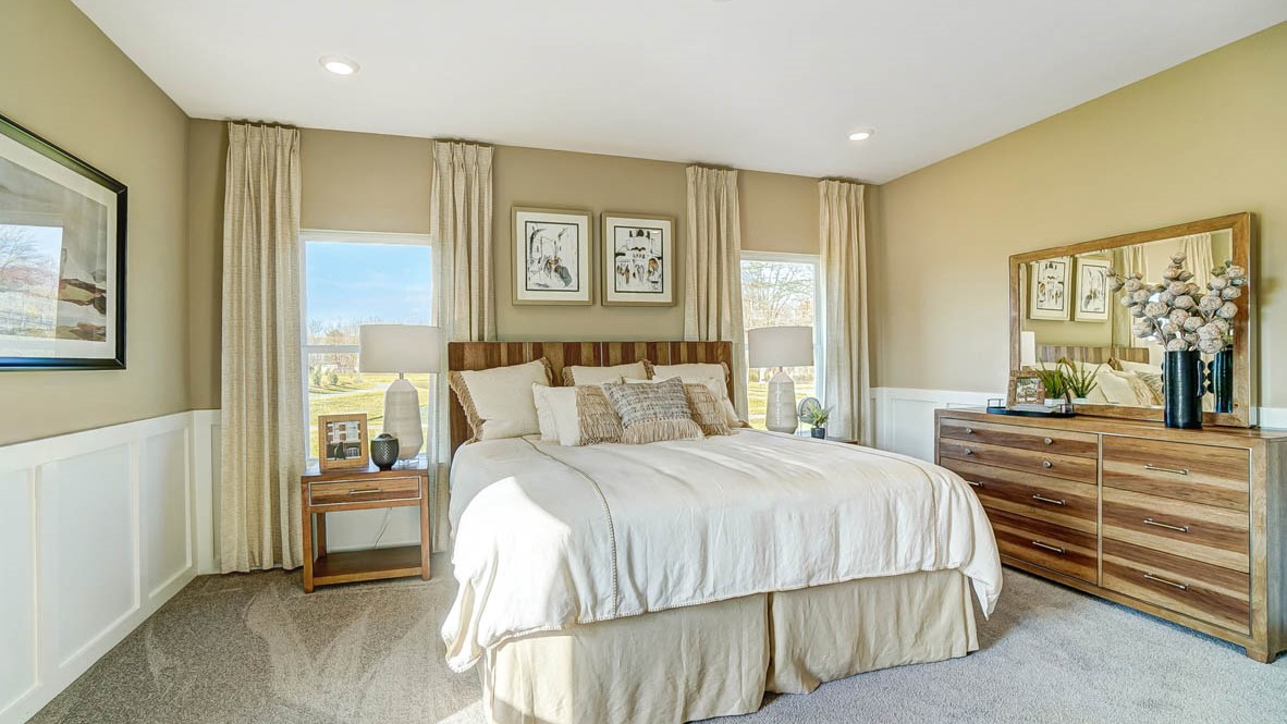 Primary Bedroom with large bed, modern art, and dresser.