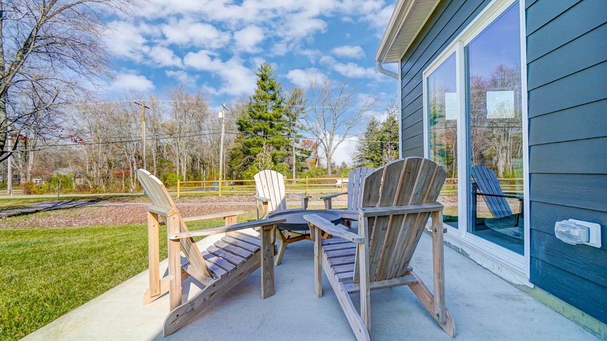 back porch with adirondack chairs.