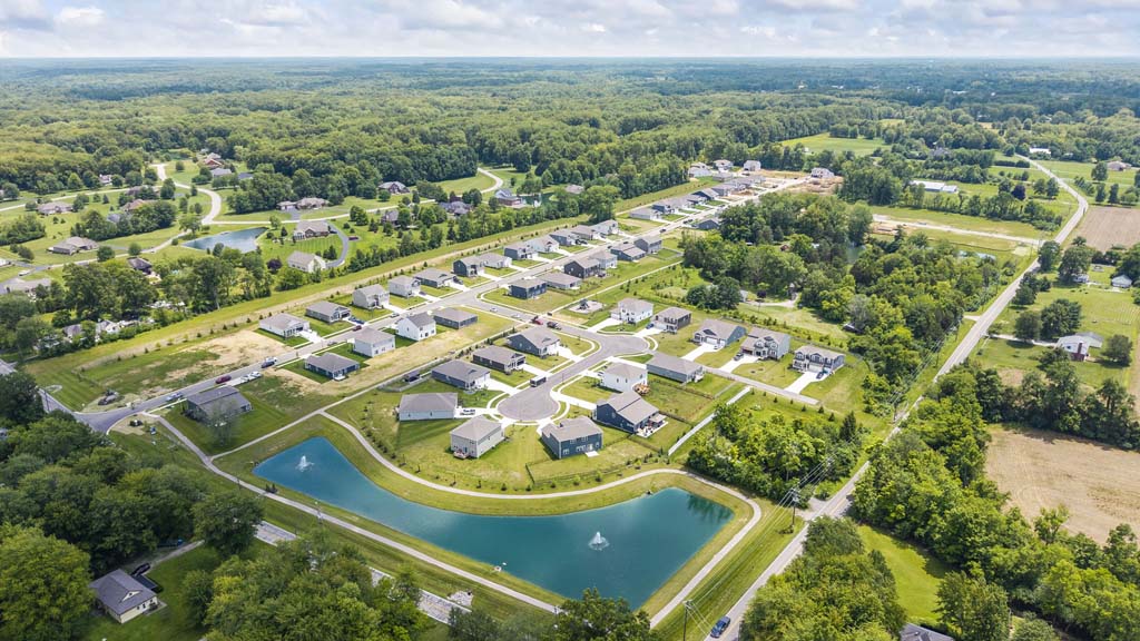 Aerial image of heritage farm with bright green vibrant grass and blue pond