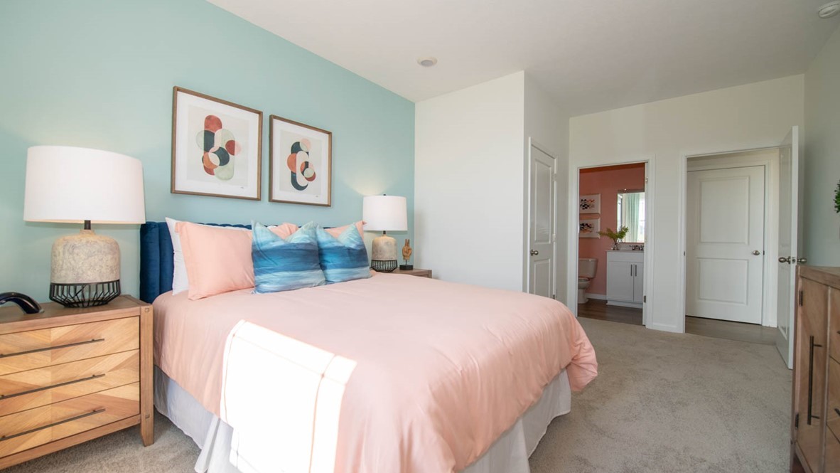 downstairs bedroom with private bath in background