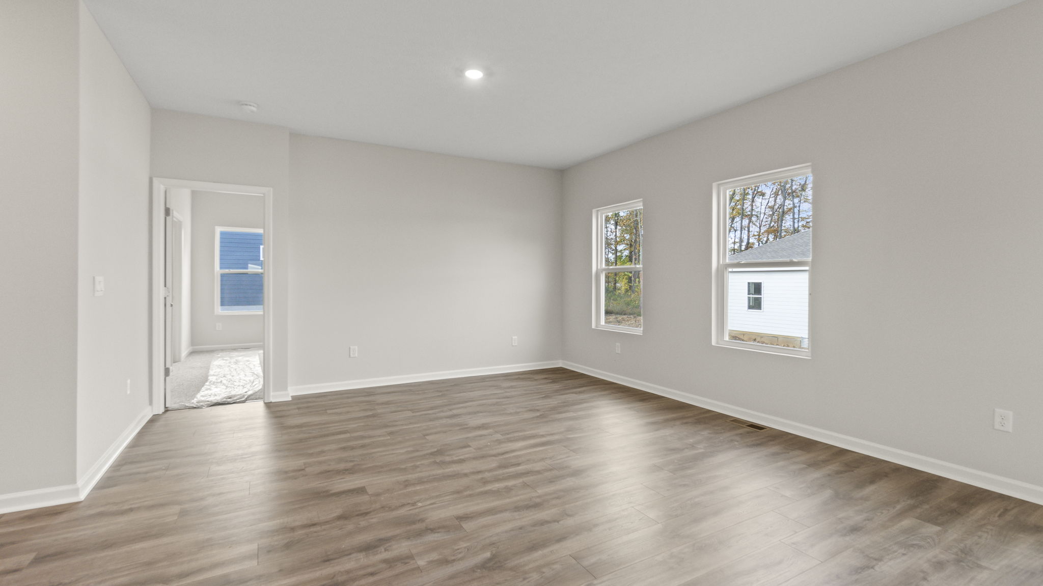 Full great room leading into primary bed