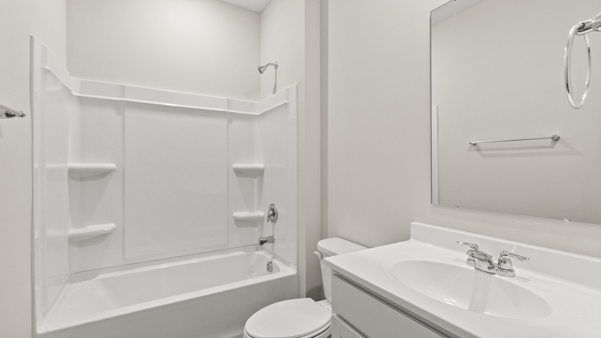 Bathroom with tub, shower, toilet, white sink, and mirror
