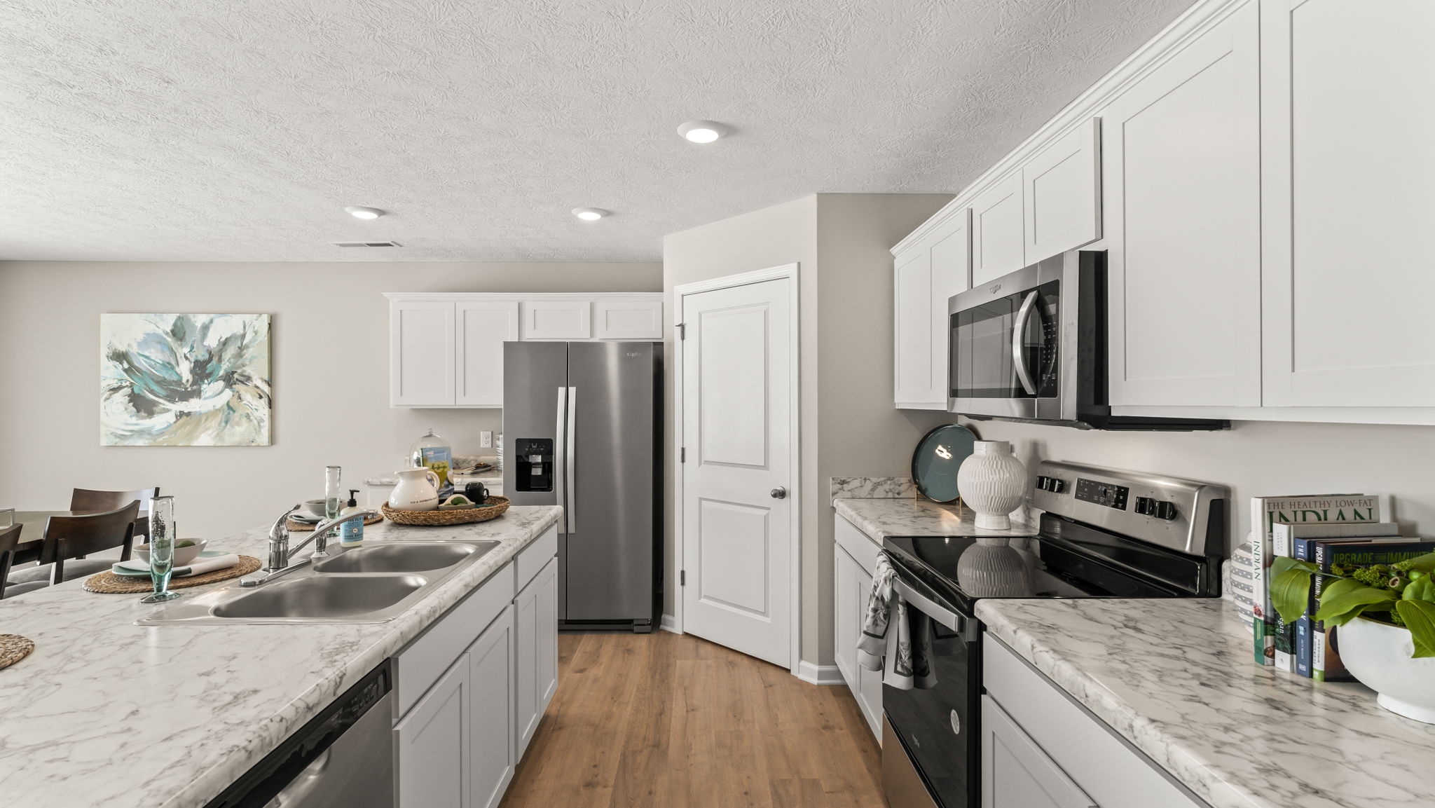 Side view of kitchen with island on the left, oven range on the right