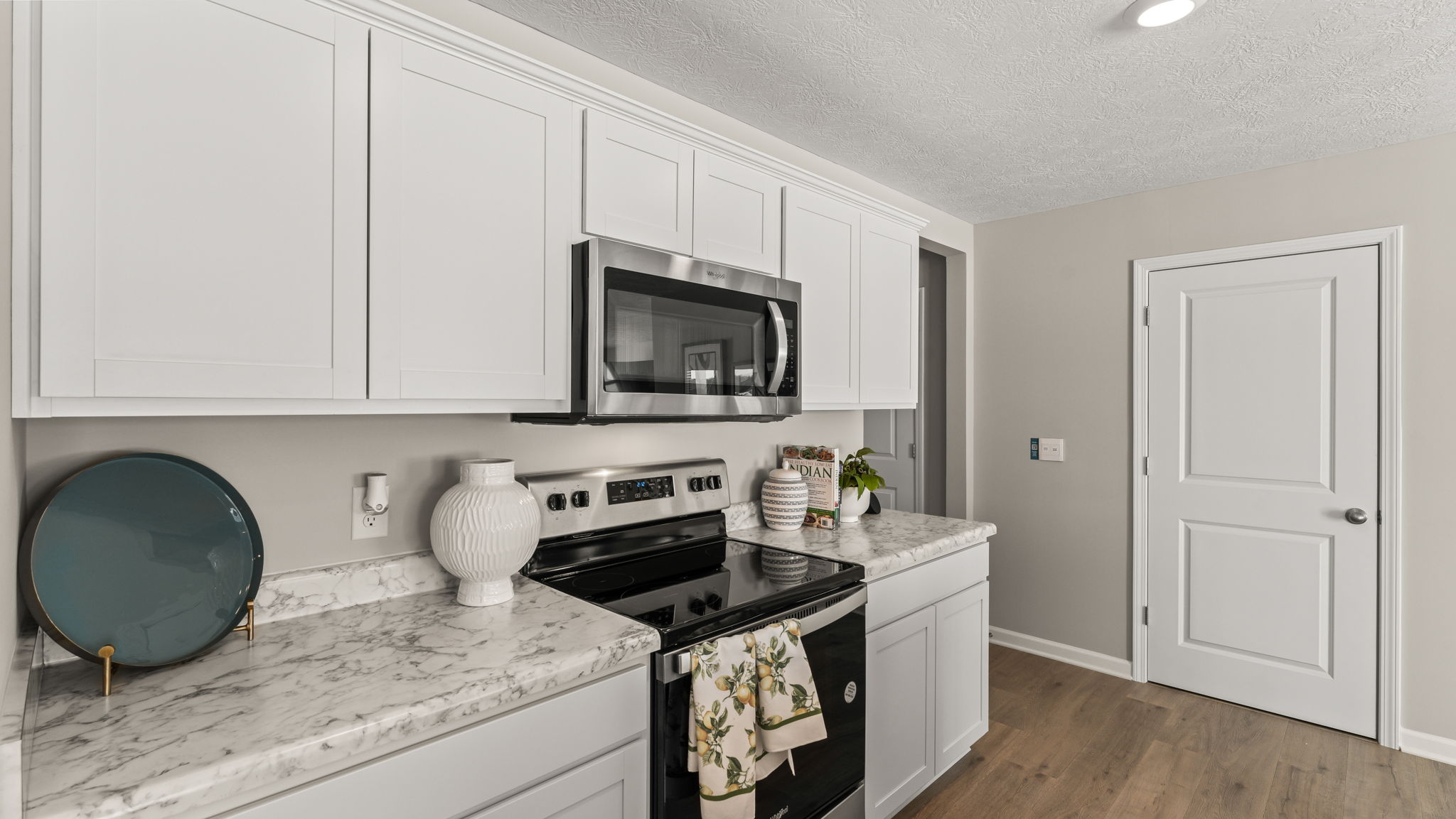 closeup of kitchen oven range between cabinetry