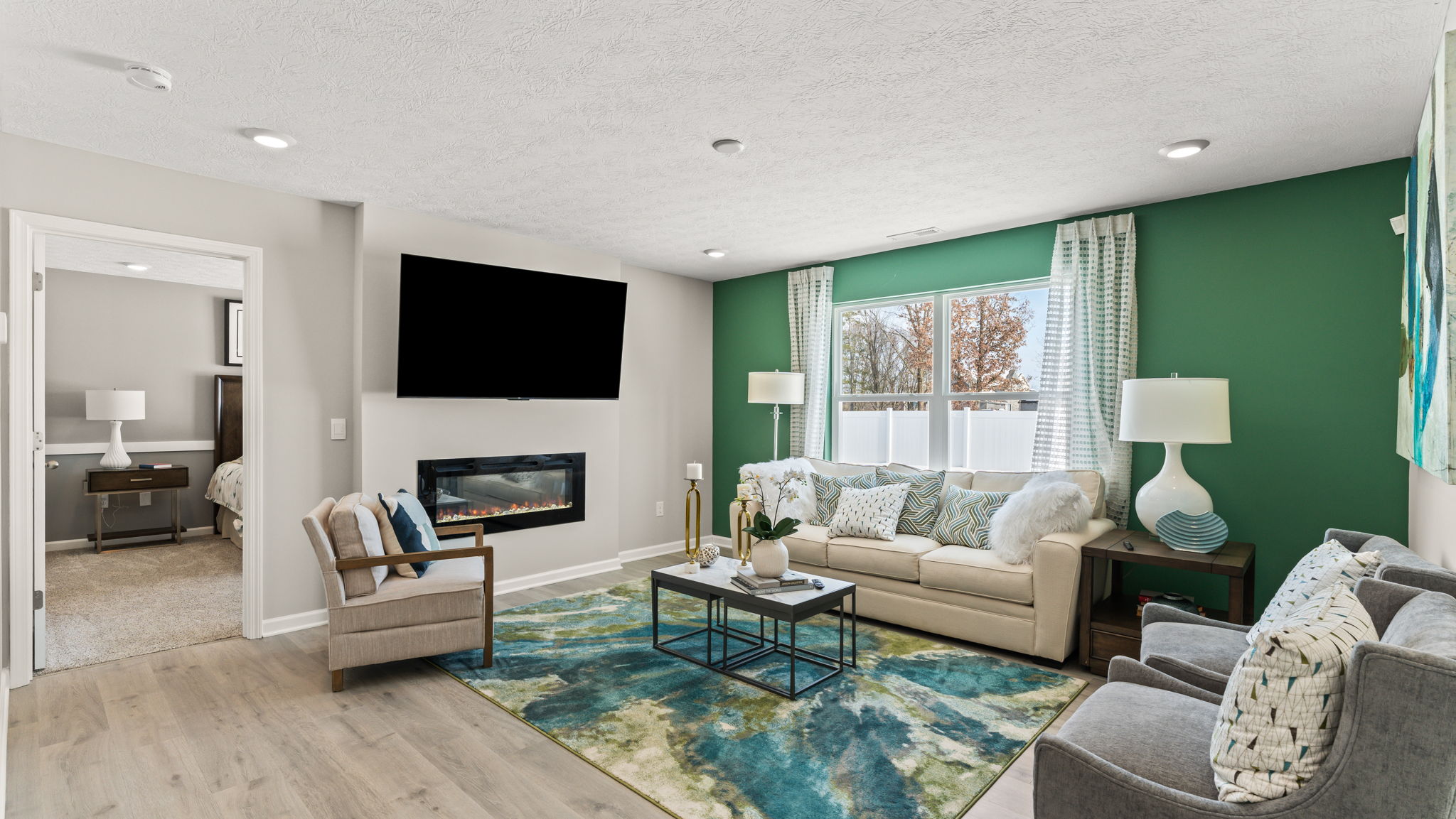 Modern home living room with cool color themes, electric fireplace, and white furniture