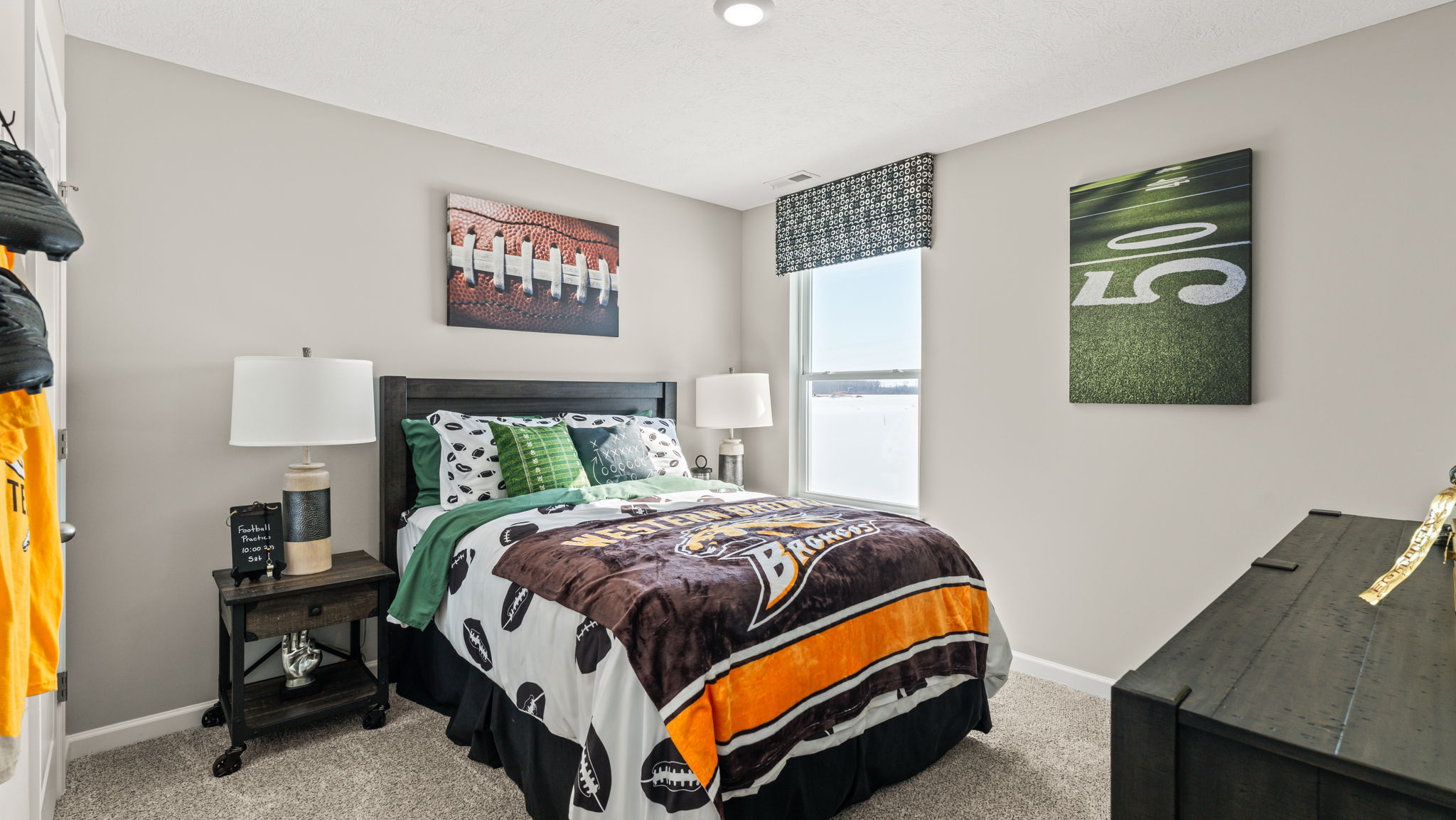 Wide image of a bedroom with sports theme