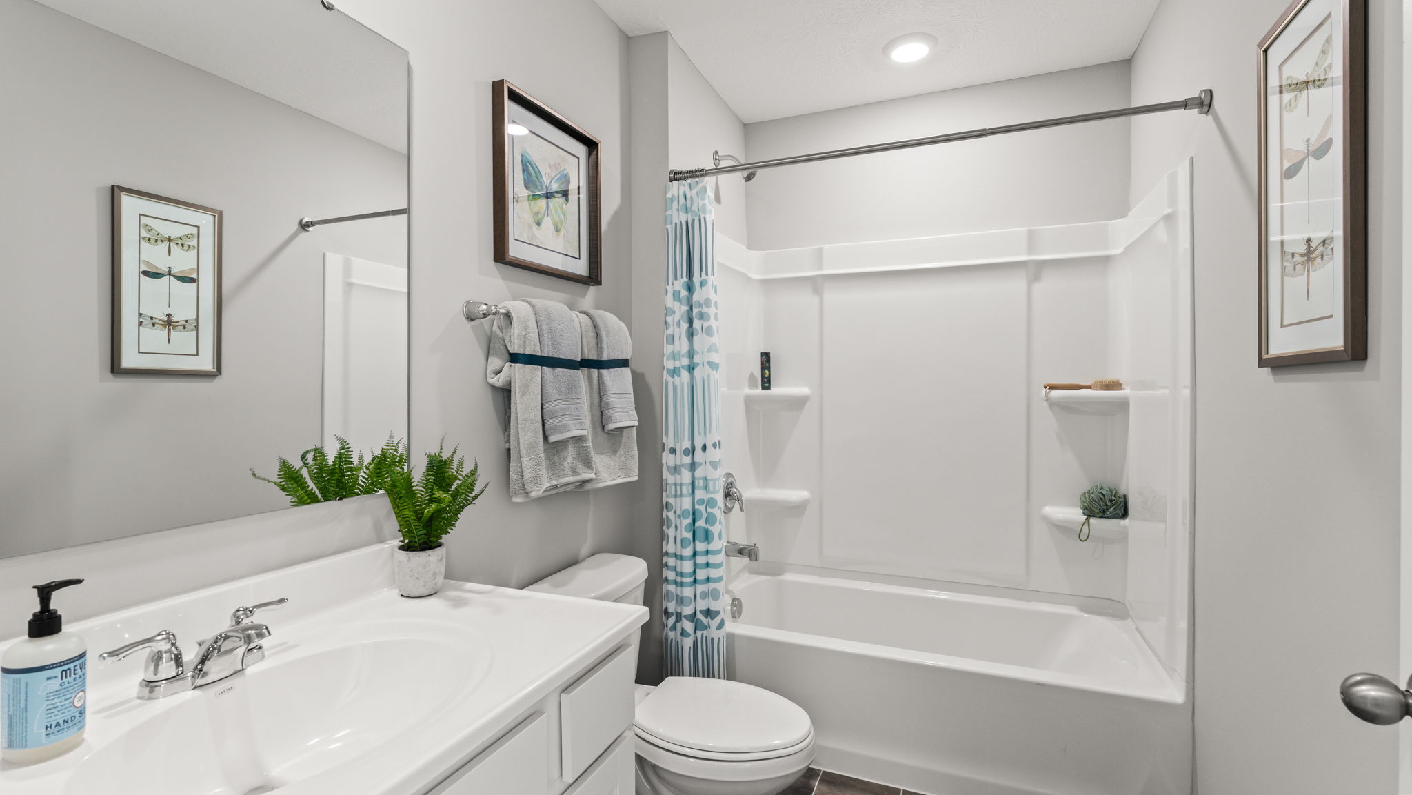 Wide angle image of bathroom with tub, sink, and toilet