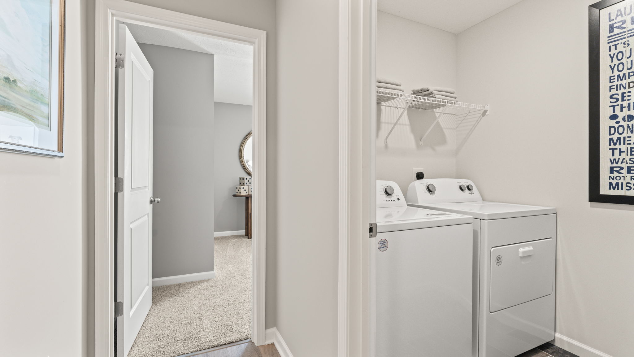 Wide image of the laundry area adjacent to a bedroom