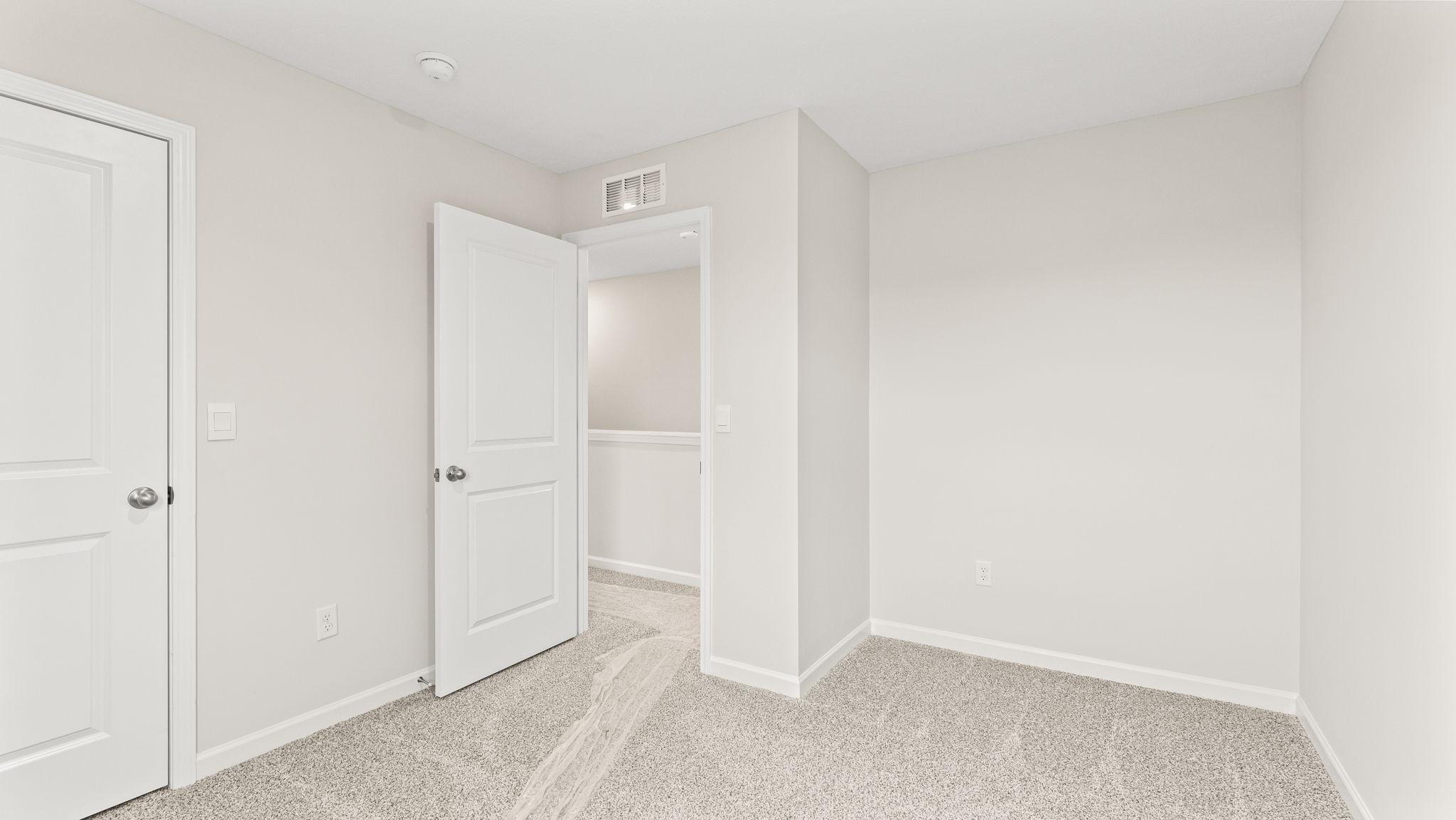 wide angle image of bedroom with door