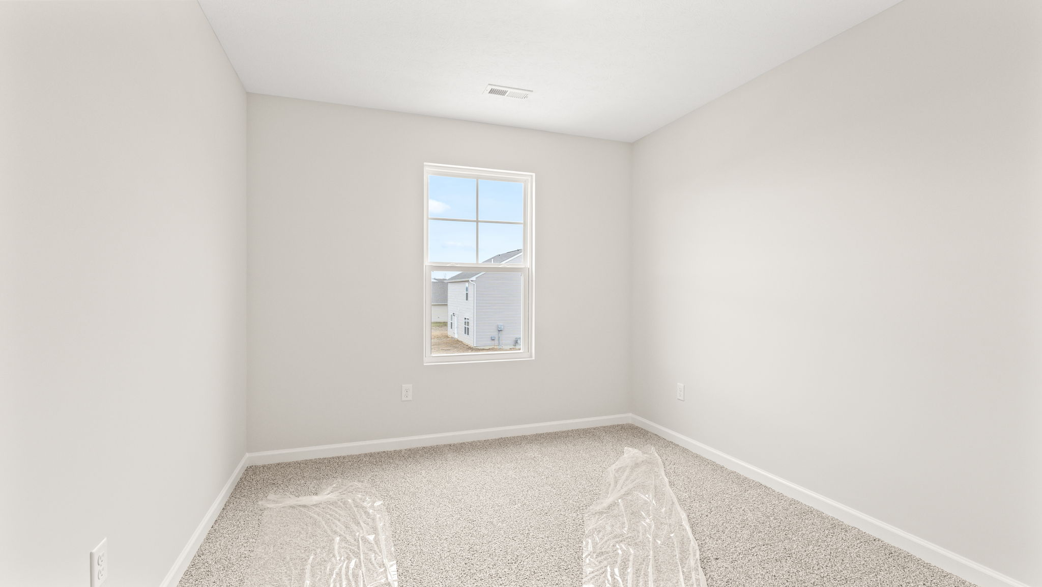 wide angle image  of bedroom with carpet and window