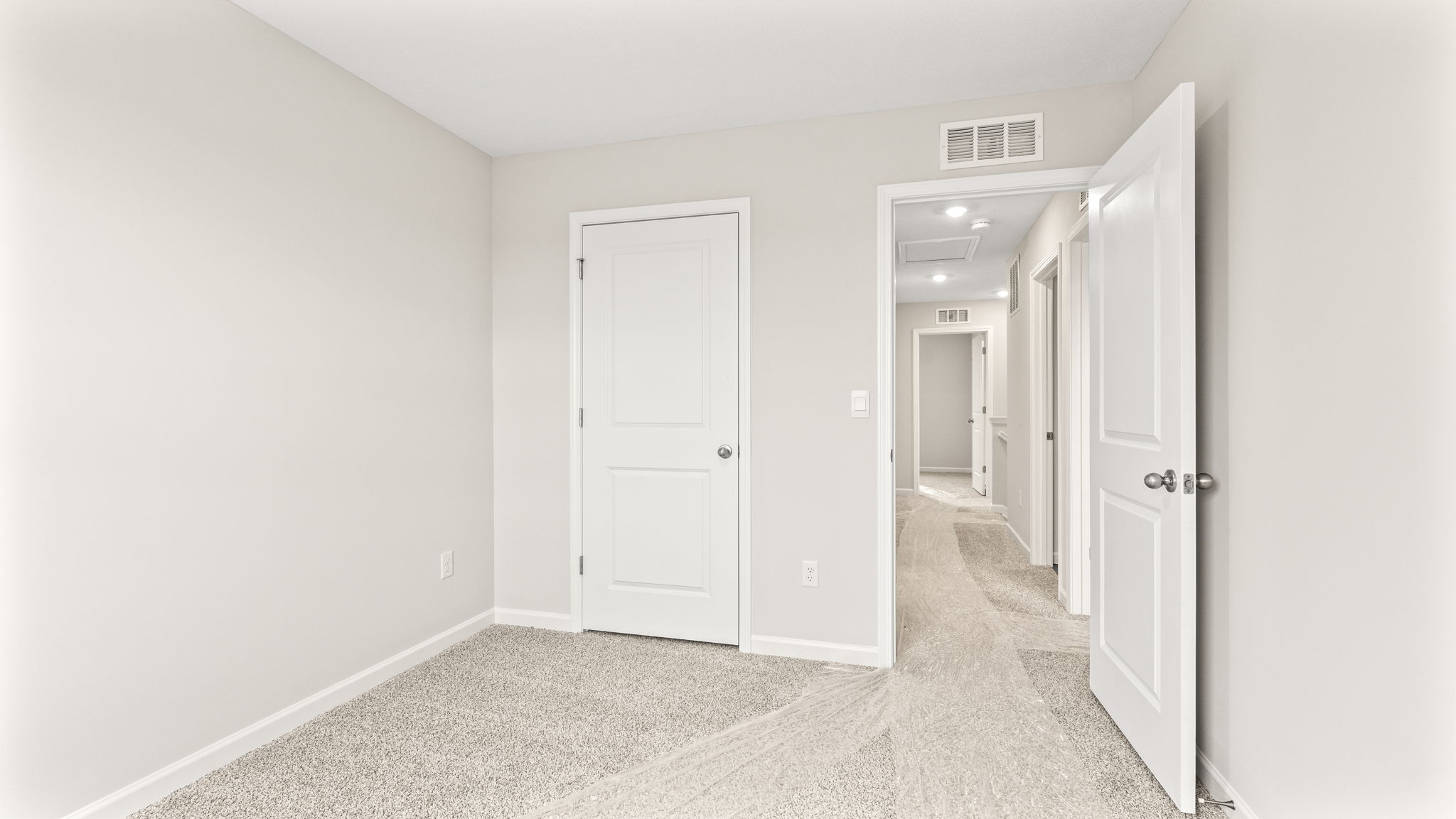 wide angle image of bedroom with door