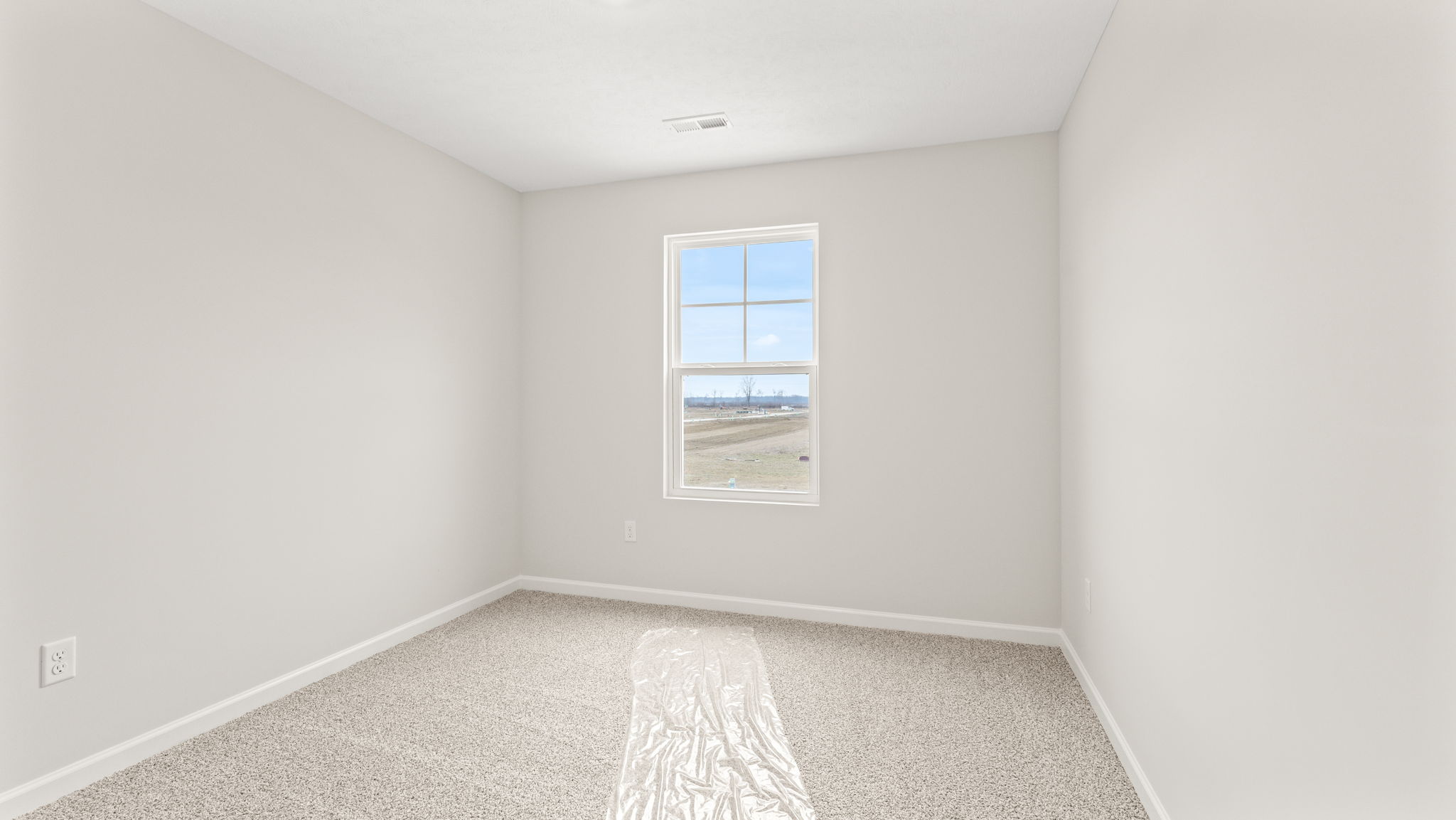 wide angle image  of bedroom with carpet and window