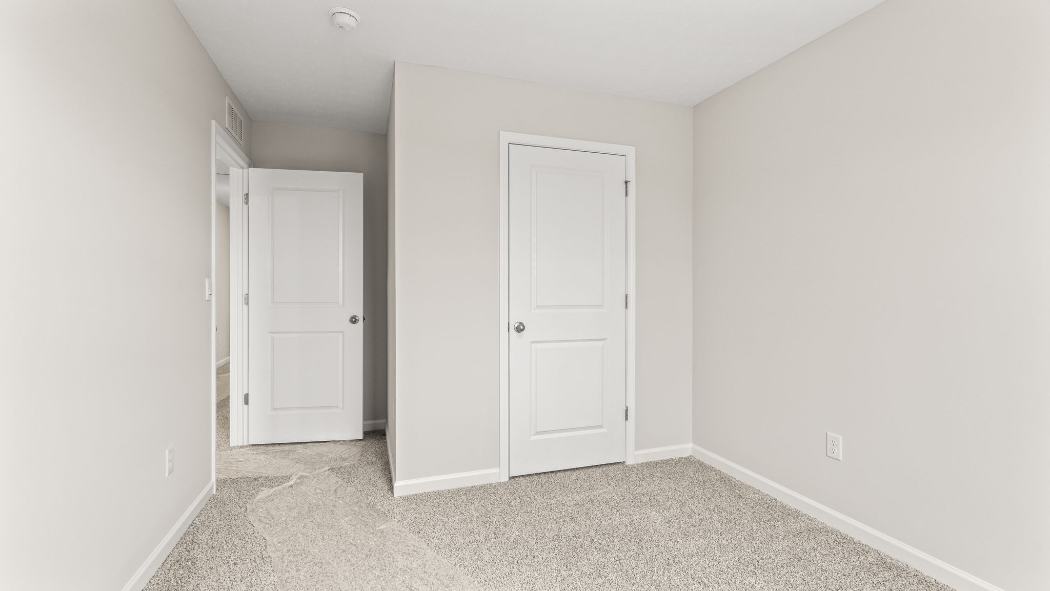 wide angle image of bedroom with door