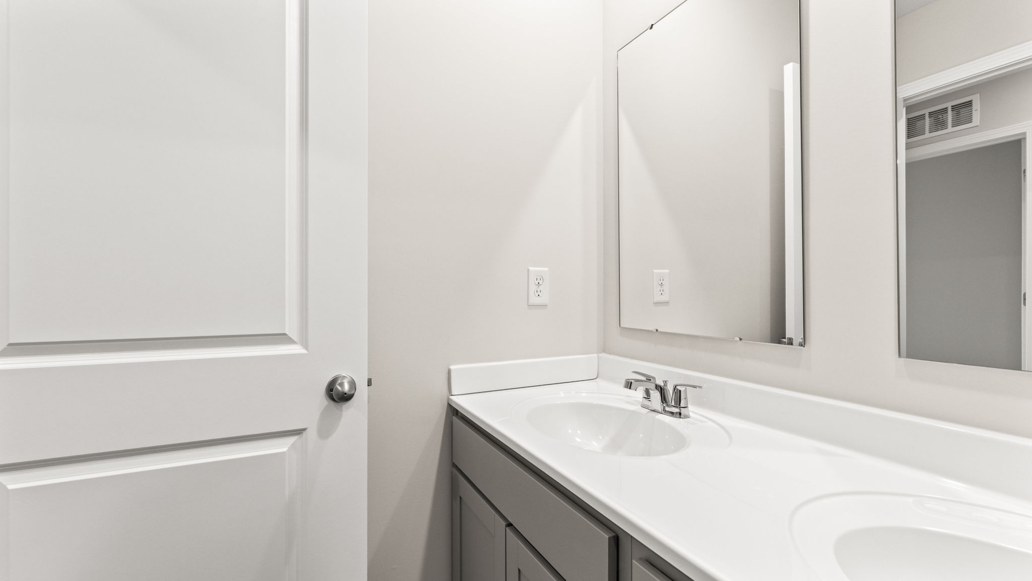 Closeup of sink and mirror in bathroom