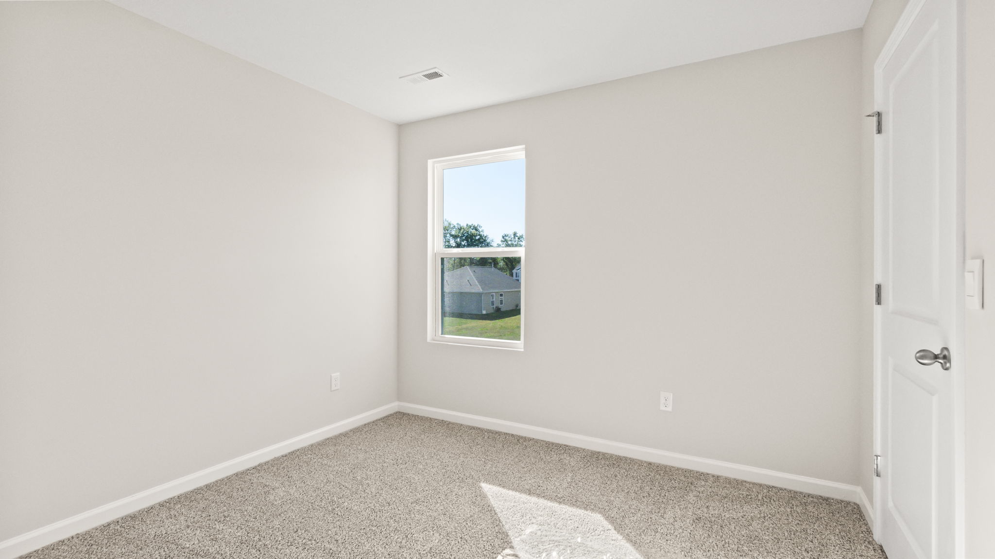 carpeted bedroom with window