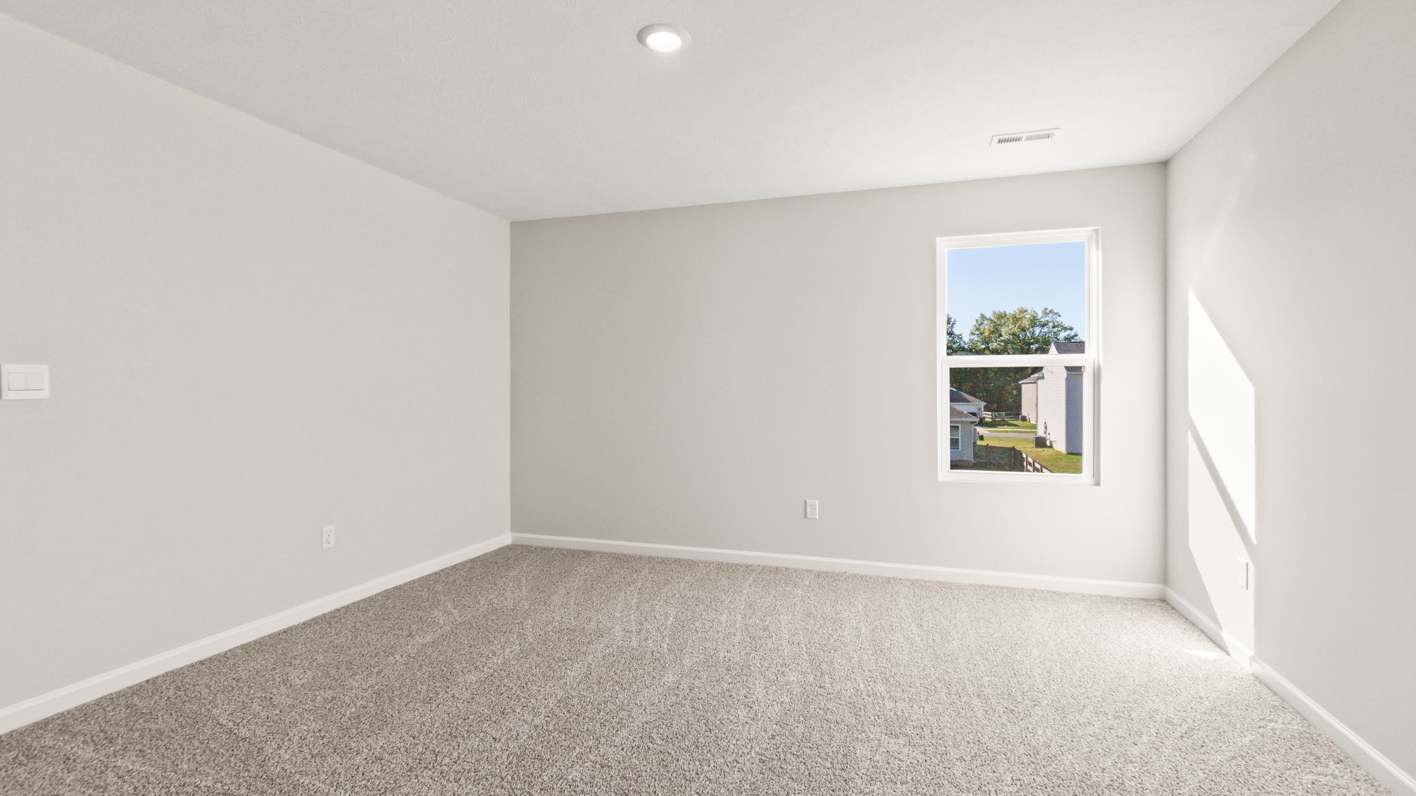carpeted bedroom with window