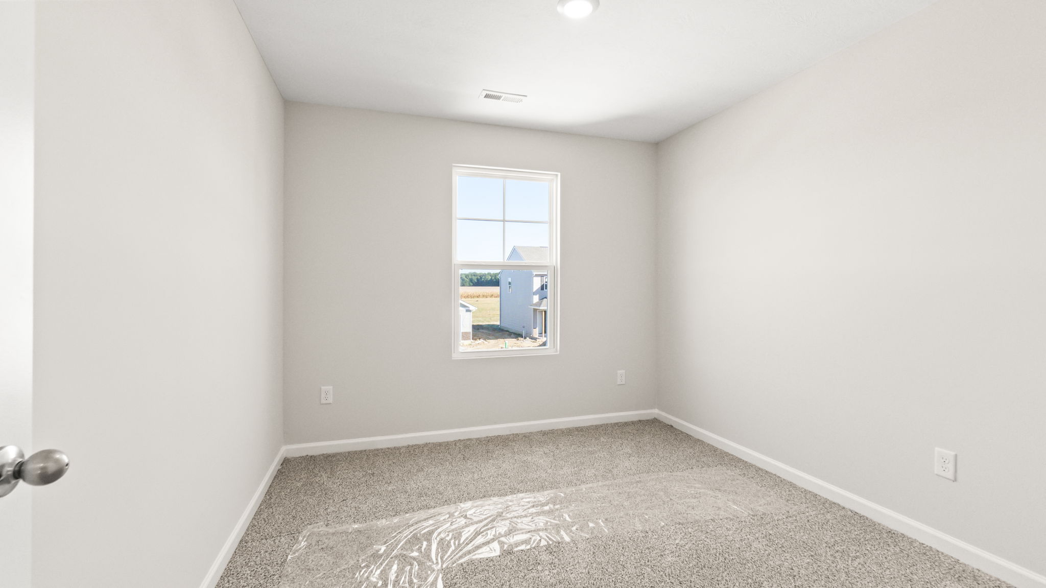 Carpeted bedroom with window