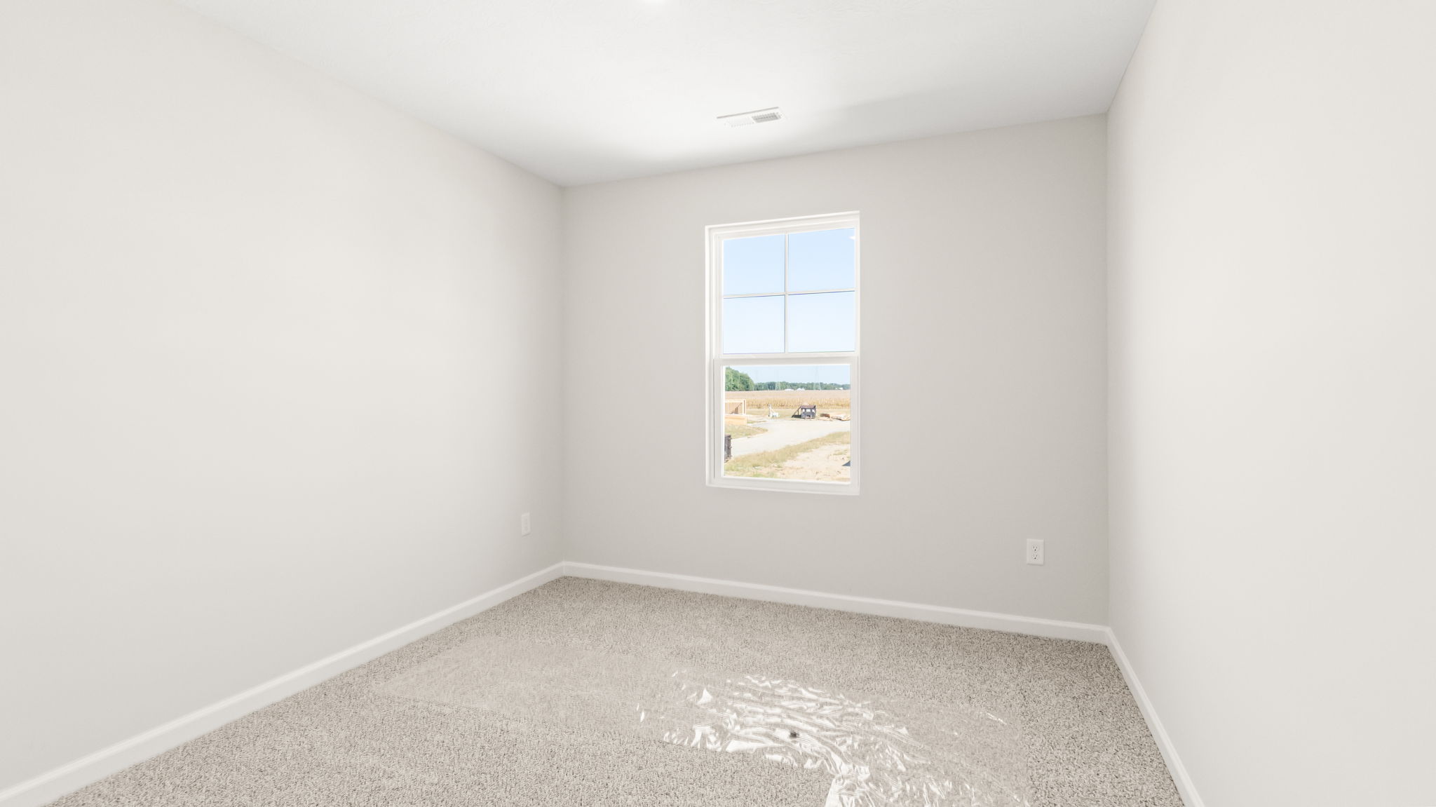 Carpeted bedroom with window