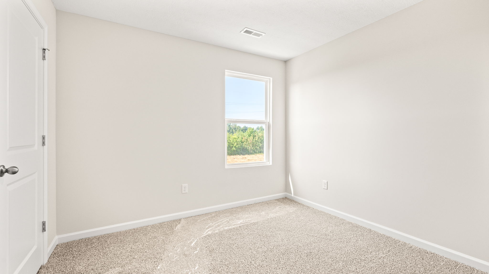 Carpeted bedroom with window