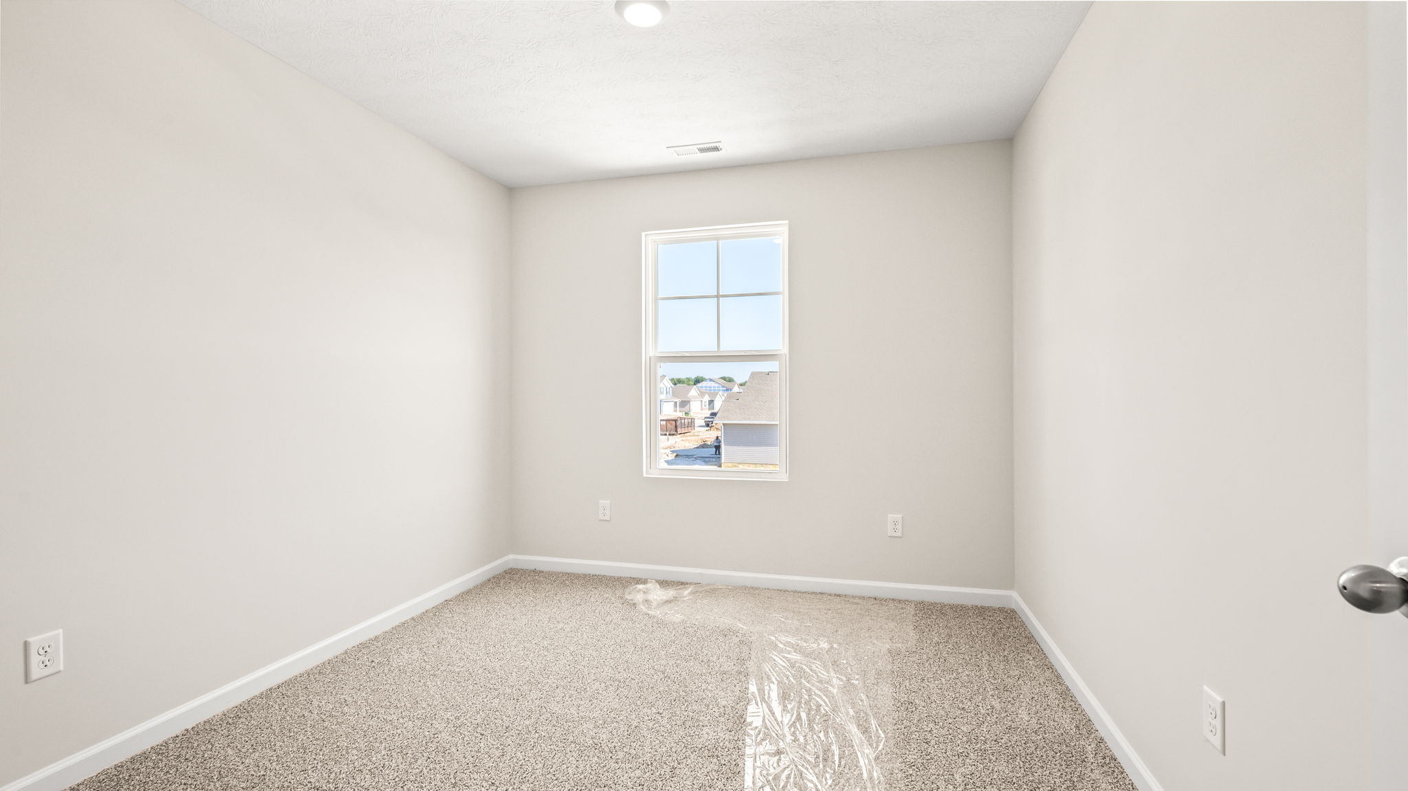 Carpeted bedroom with window