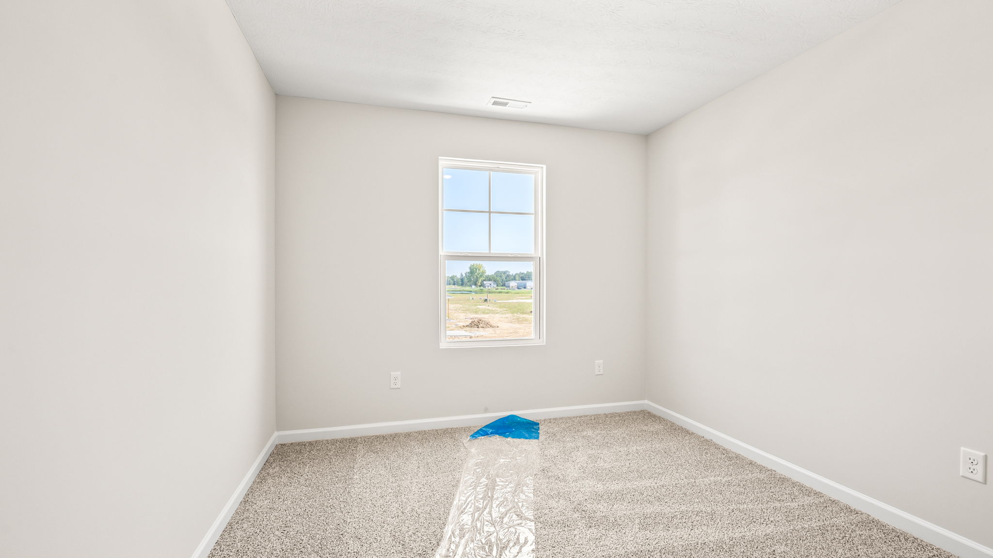 Carpeted bedroom with window