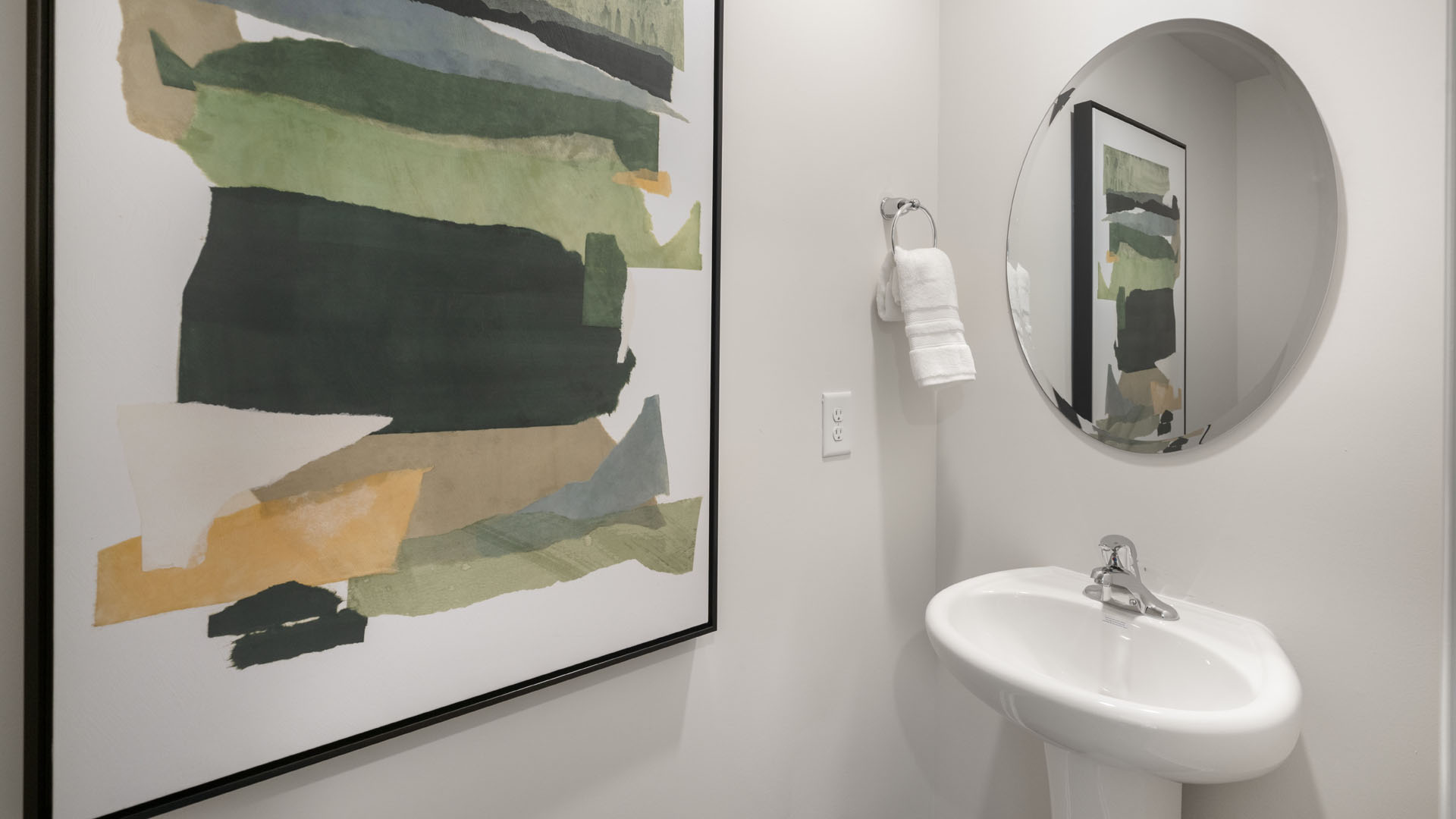 half bathroom with modern art sink and mirror.
