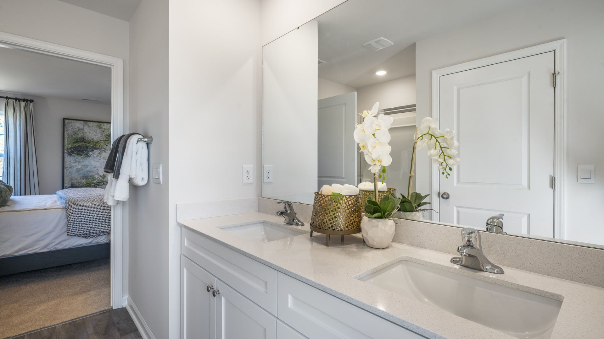 Dual Vanity sink with granite countertops and large mirror.