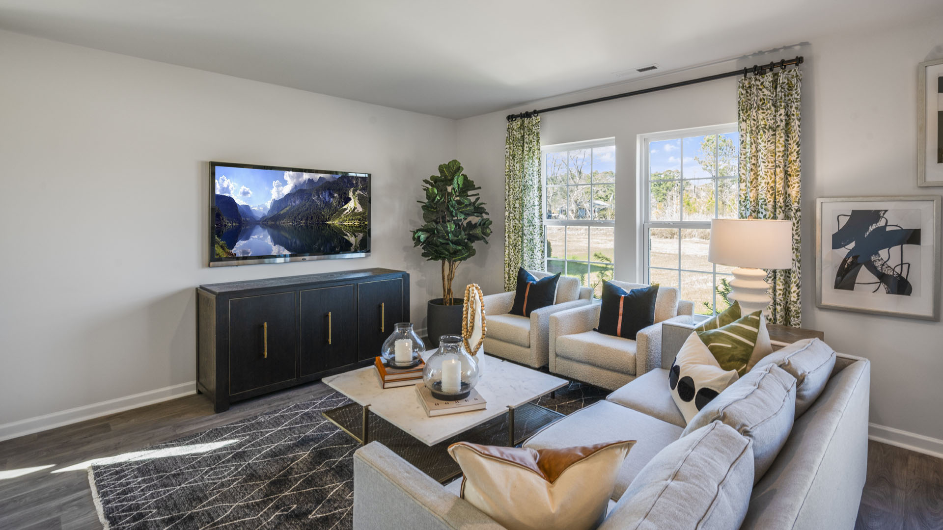 Open Concept living room with a sofa and 2 recliners and a tv.