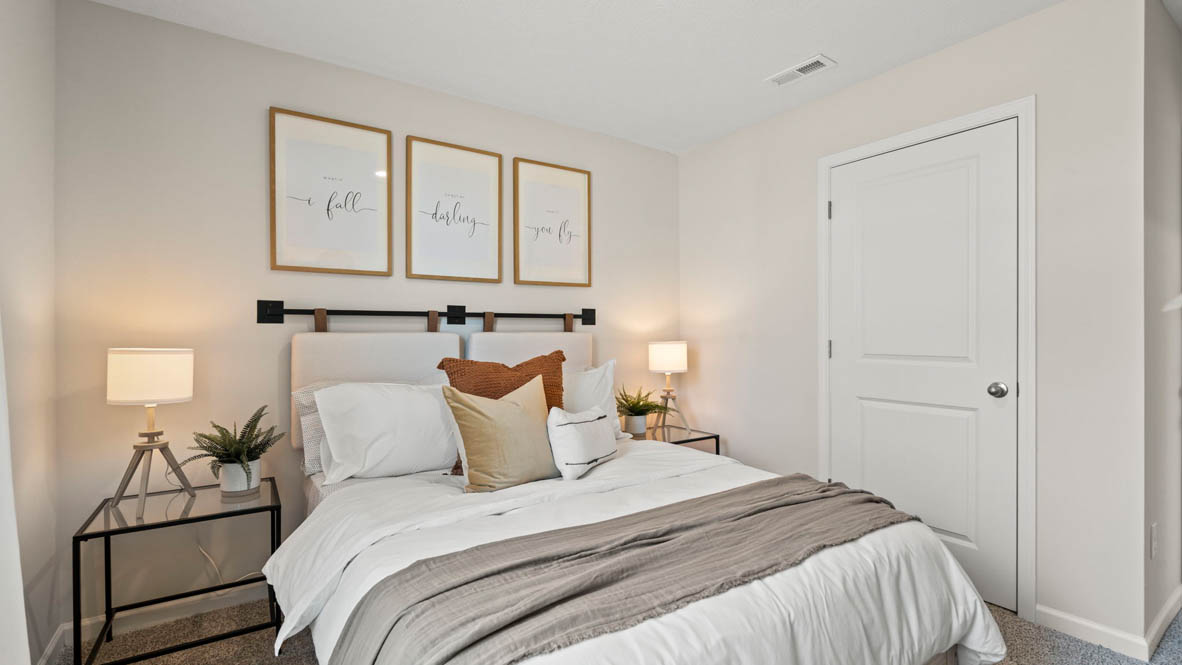 Side bedroom with beautiful decorations and large bed.