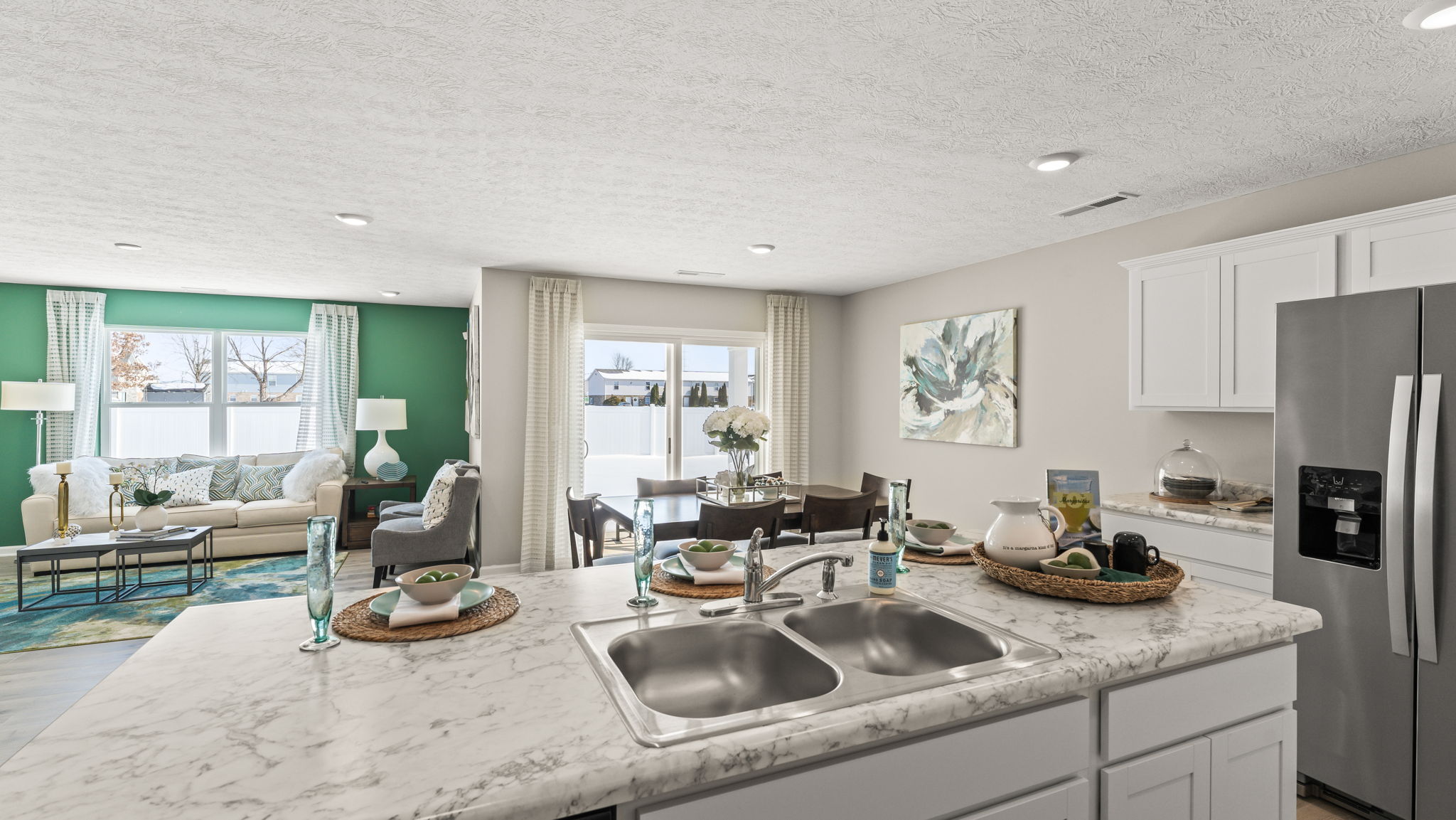 Perspective shot of the kitchen island from the island with view of modern dining area