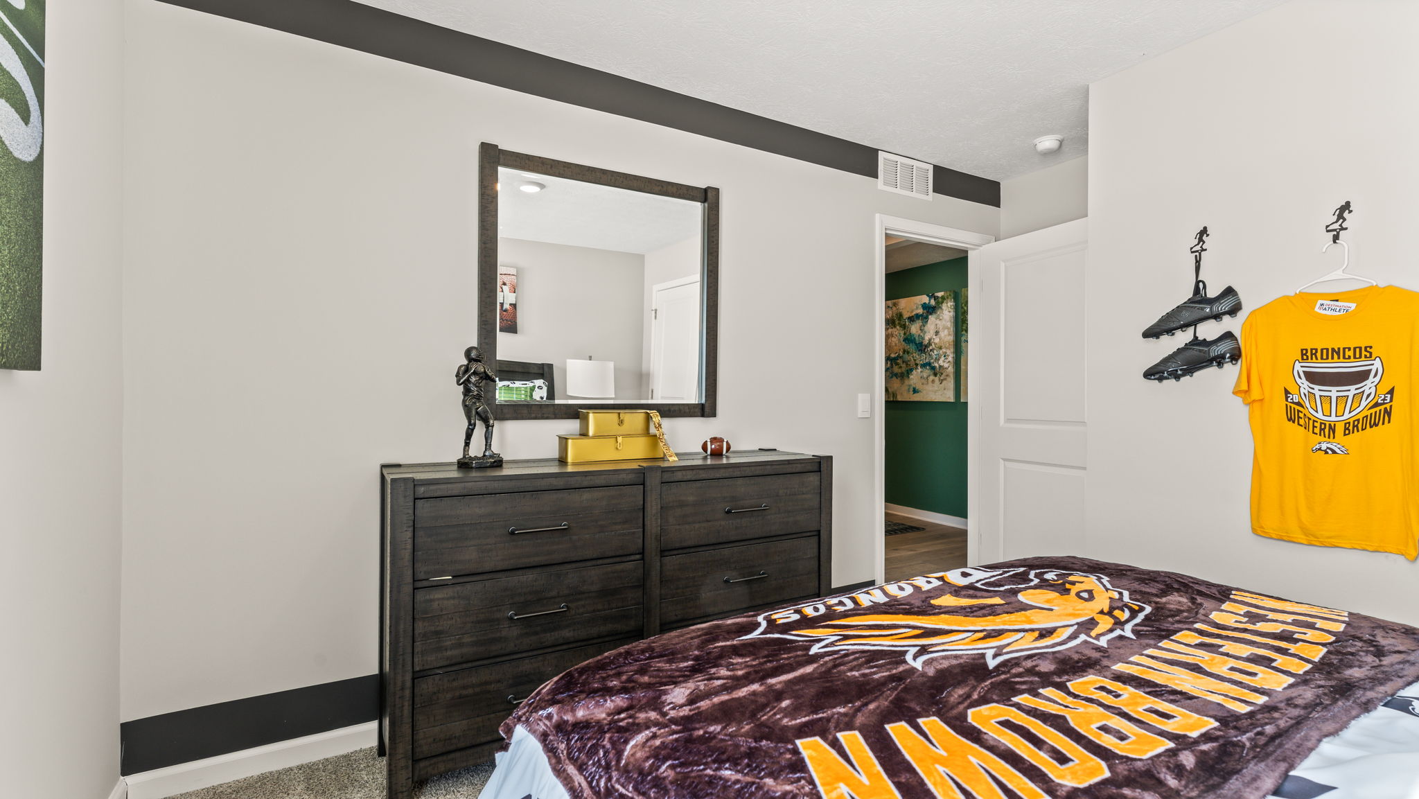 Perspective image of bed with western brown broncos blanket