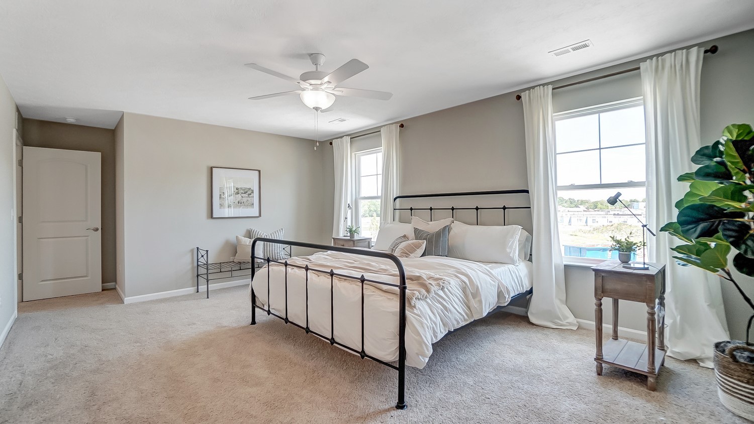 Primary Bedroom with large bed and elegant decorations.