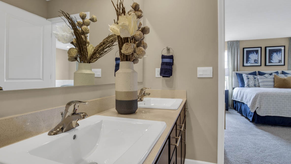 Primary bathroom sink with view of primary bedroom