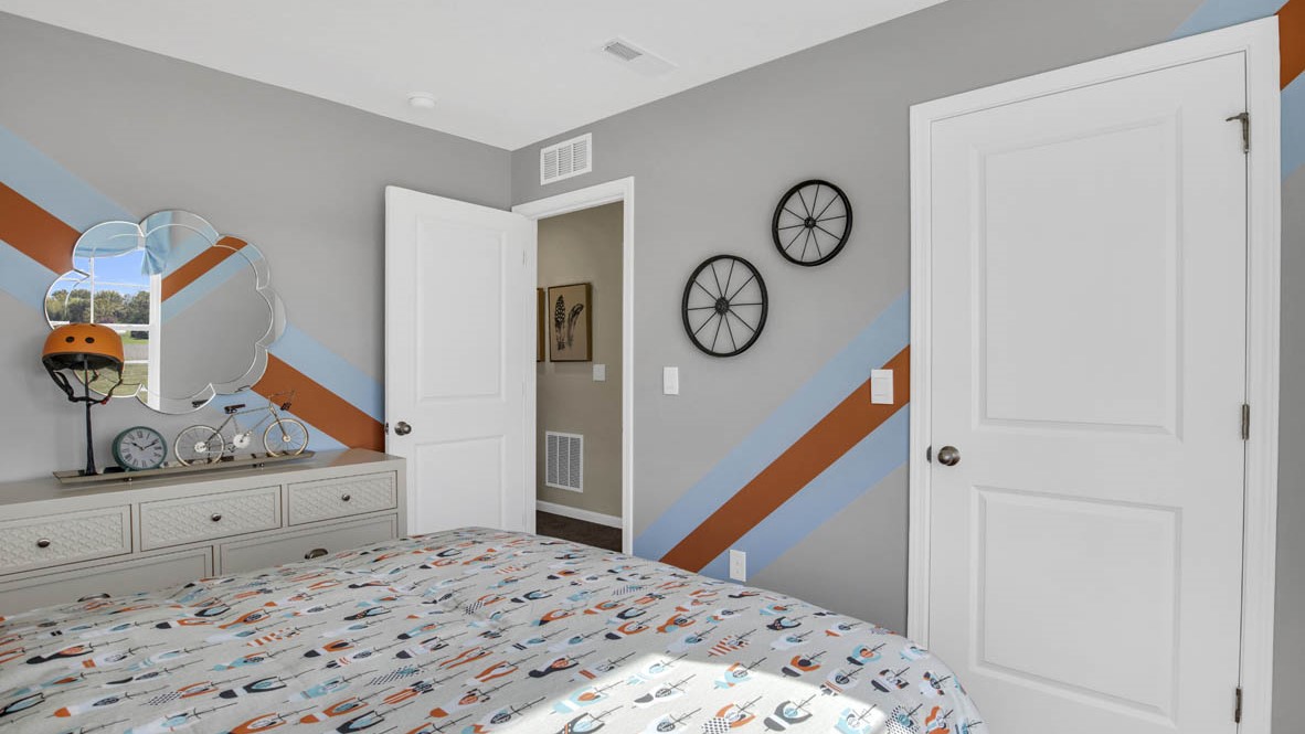 Train themed bedroom with stripes on the wall.