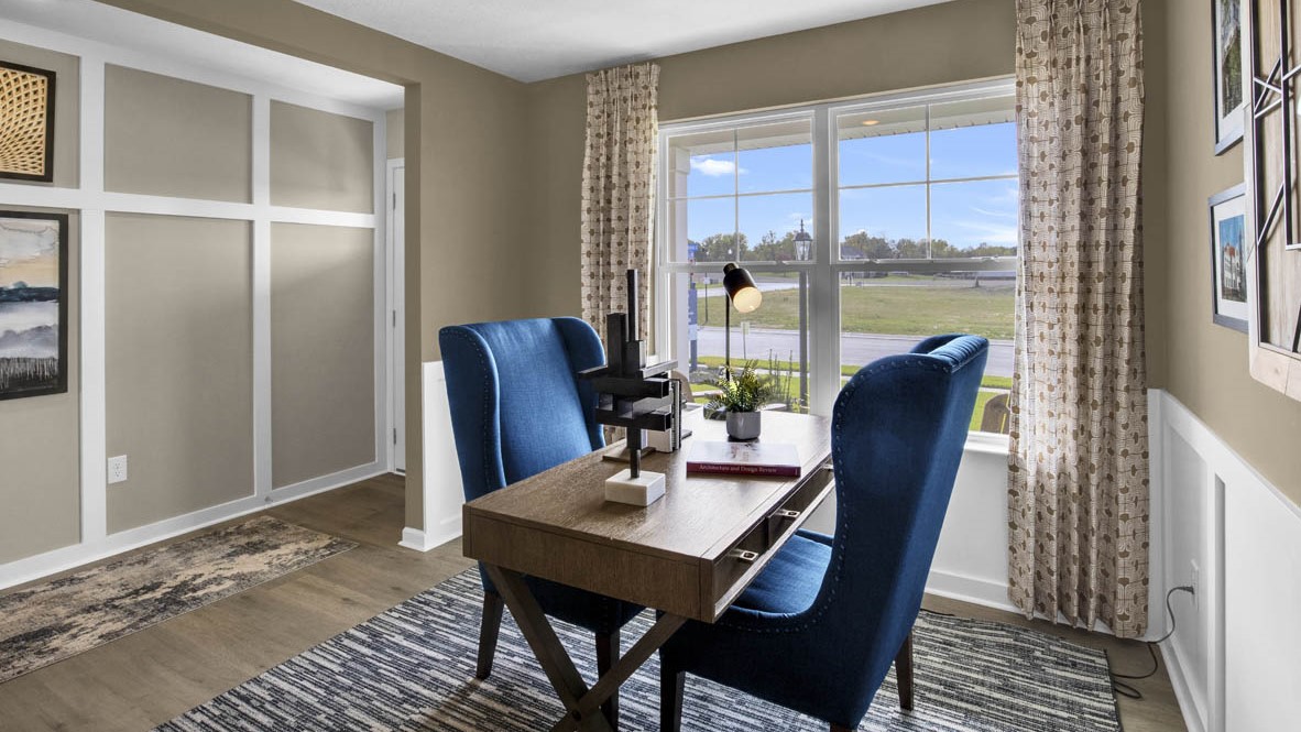 Office desk with table, blue chairs, and window