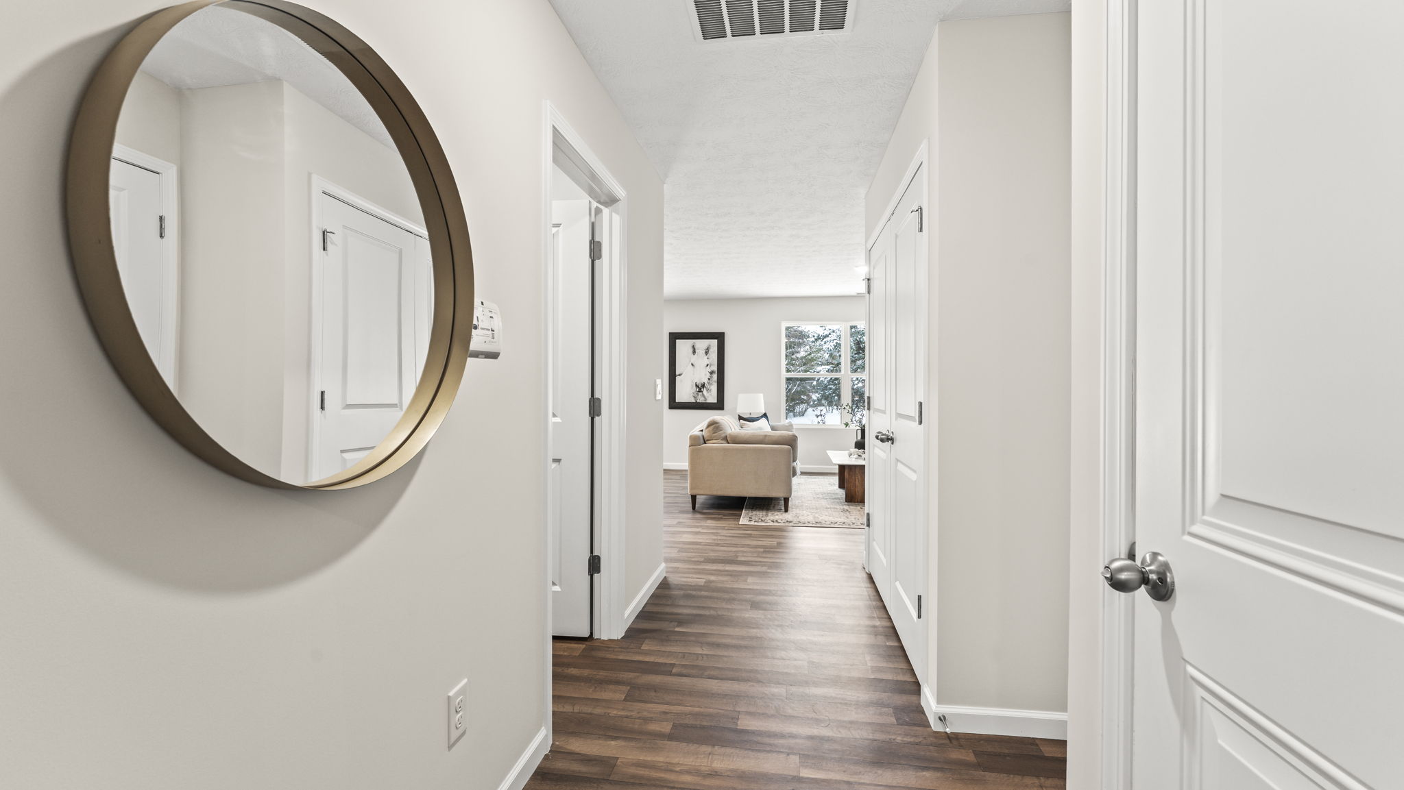 Front hallway with natural light, modern door design, upstairs access and interior sightlines throughout