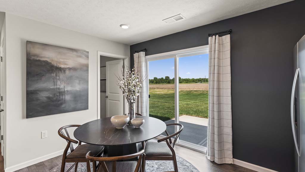 Kitchen table with flowers and view of the sliding door to the backyard