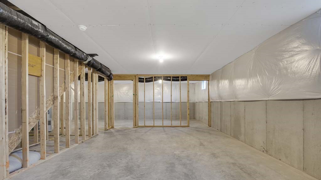 Basement with framing of 2 doors and concrete bottom.